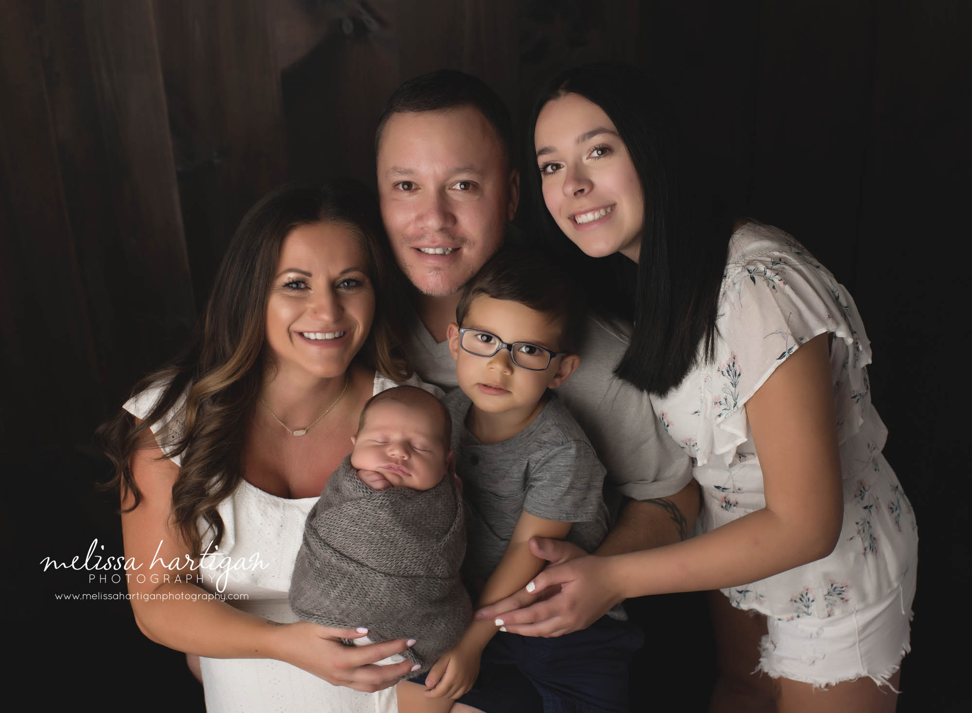 mom dad older daughter and two sons big brother newborn son family photography pose newborn photographer CT
