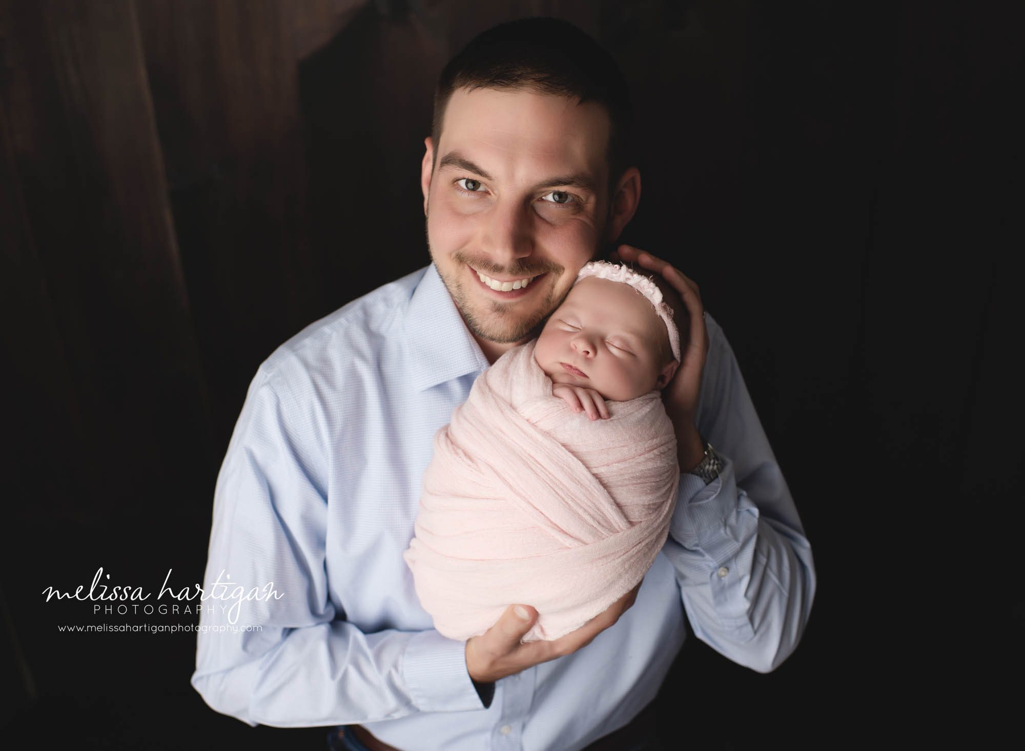 dad holding newborn daughter pose CT newborn photography