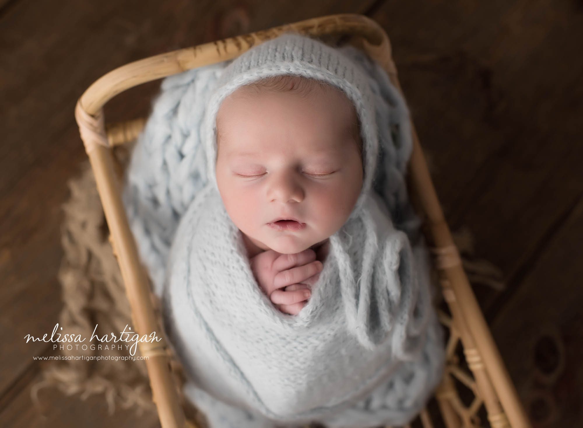 newborn baby boy wrapped in blue wrap posed in basket newborn photography Connecticut