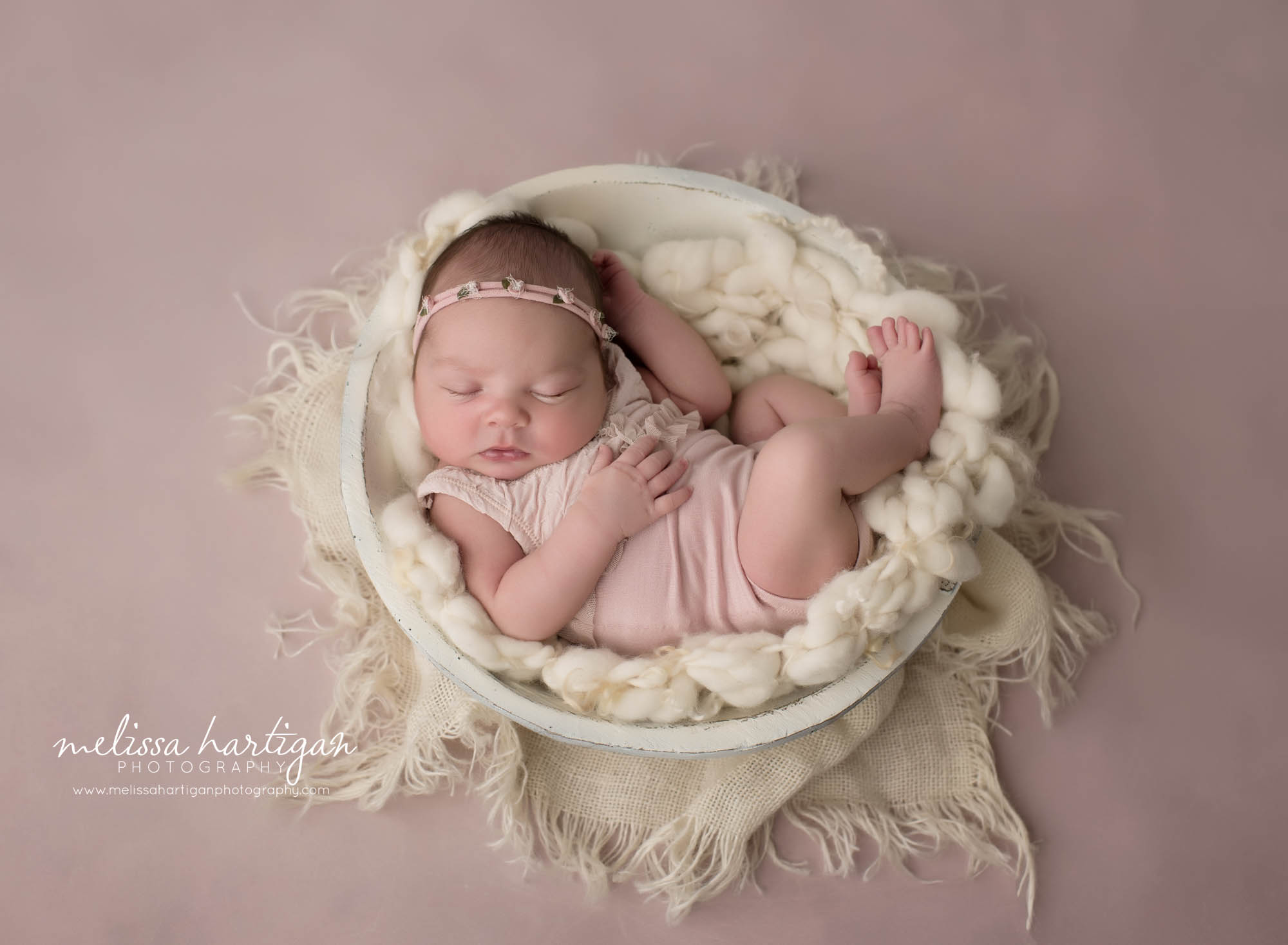 newborn baby girl wearing pink outfit posed in wooden cream bowl CT newborn photography