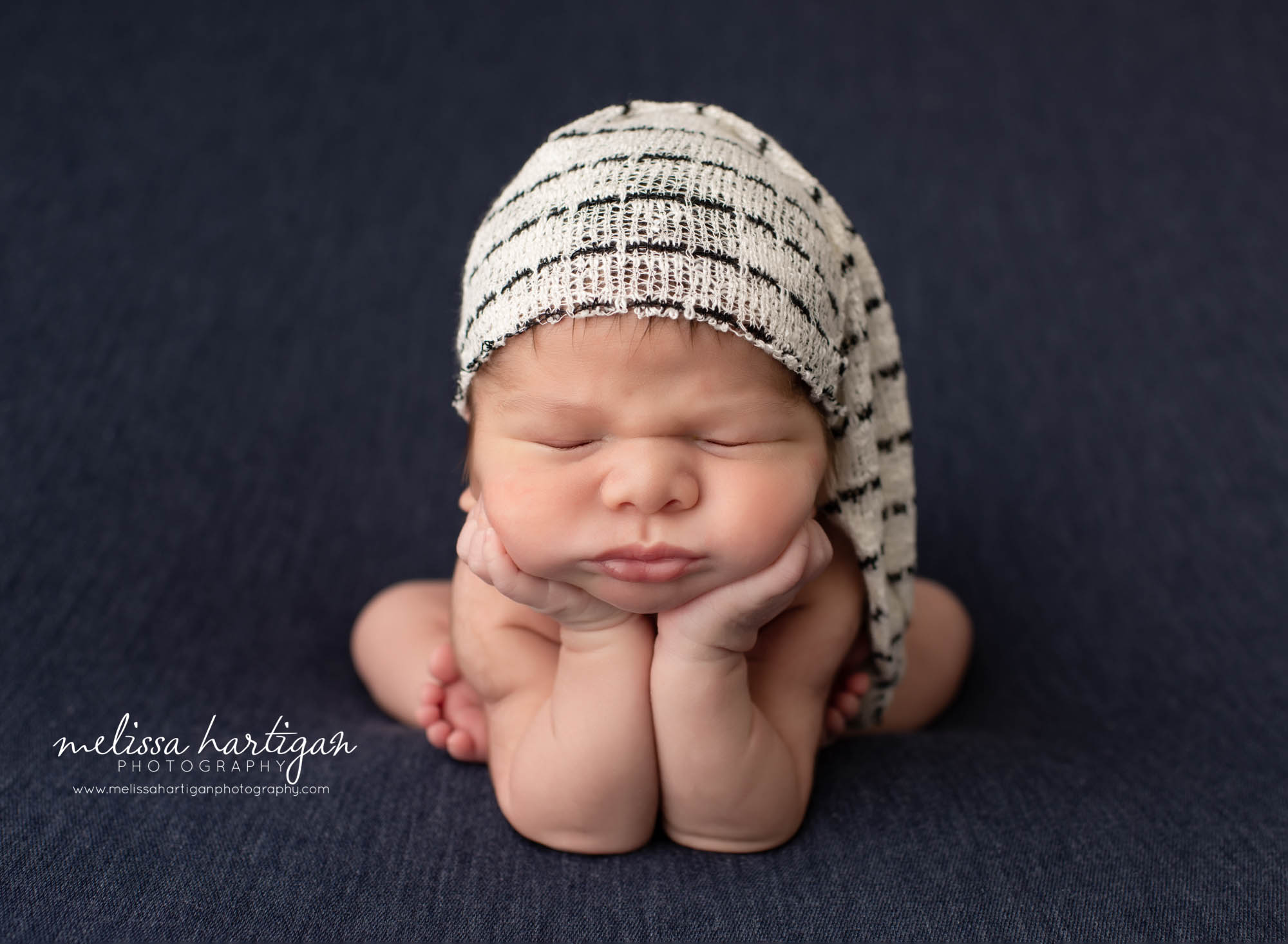 newborn baby boy wearing sleepy cap posed froggy pose vernon CT baby photography