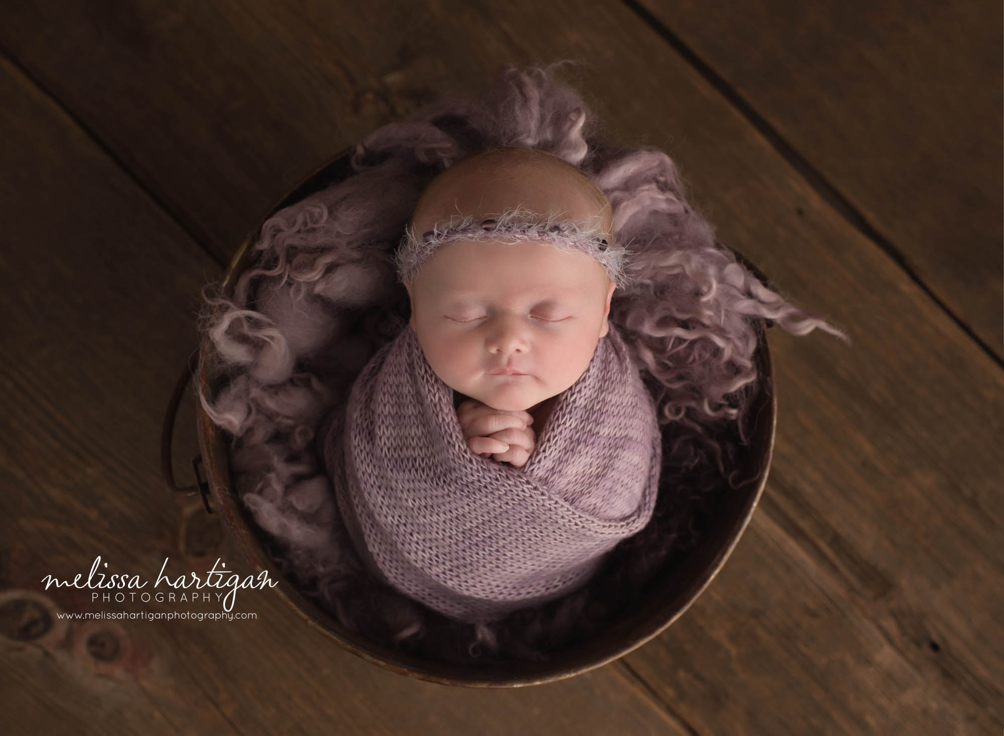 newborn baby girl wrapped in purple wrap wearing purple headband CT newborn photography