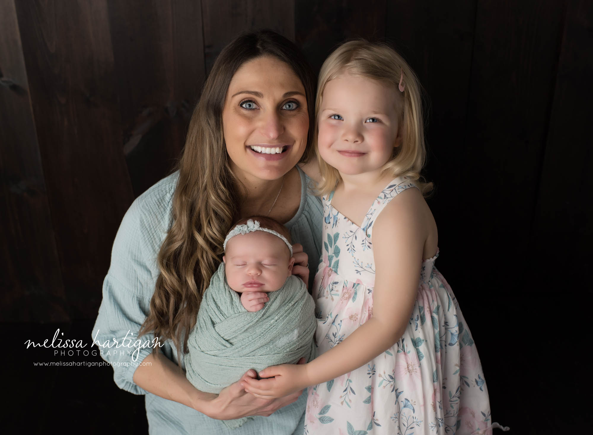 mom with two daughters family pose newborn photorgaphy