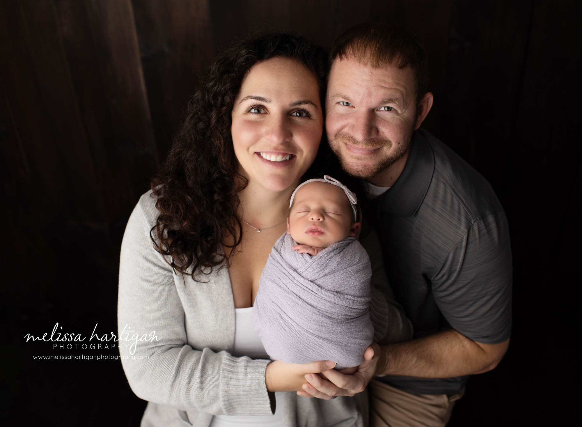 mom dad holding newborn daughter parents pose newborn photography CT