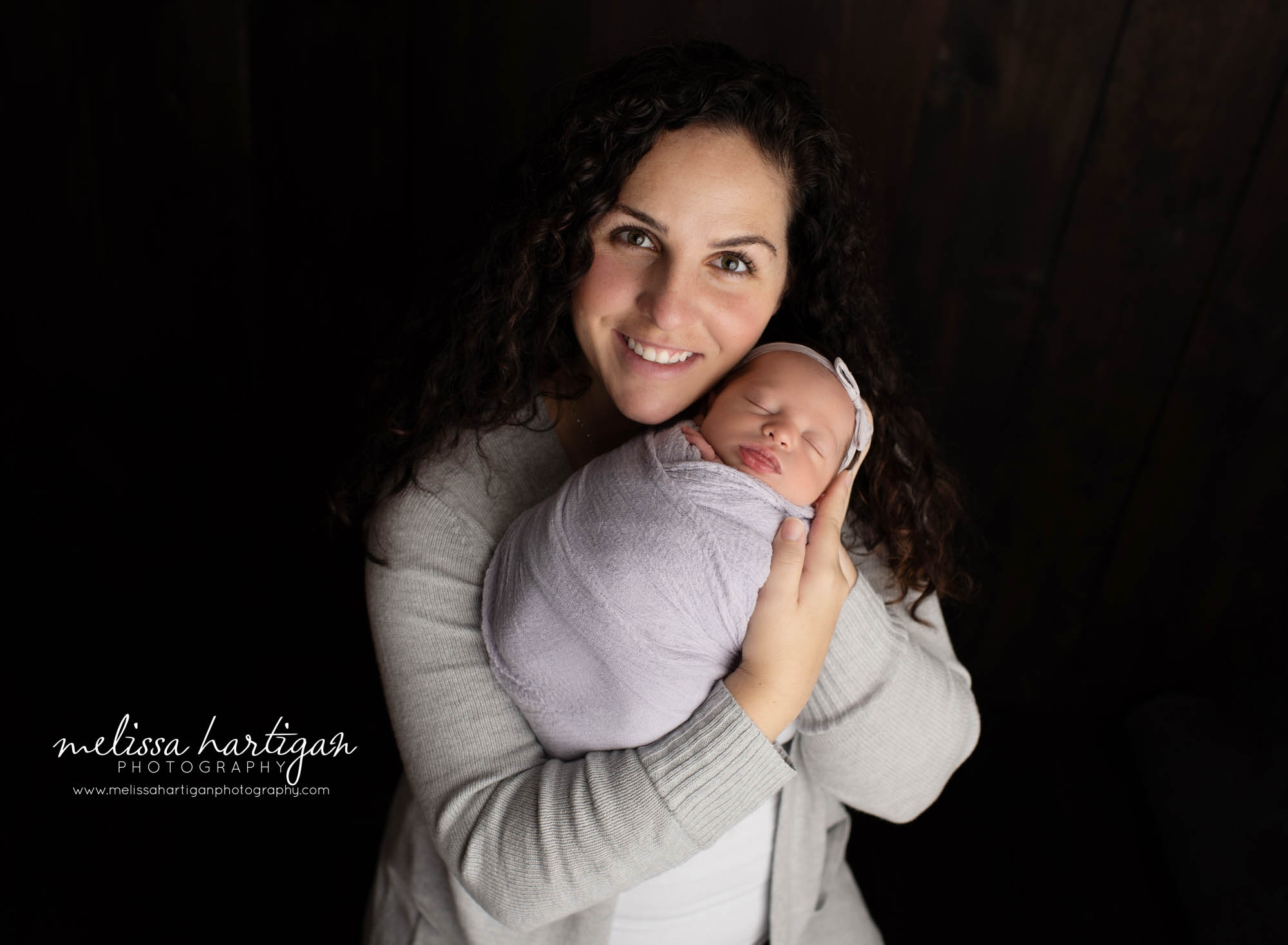 mom holding newborn daughter family parents pose newborn photography CT newborn photographer