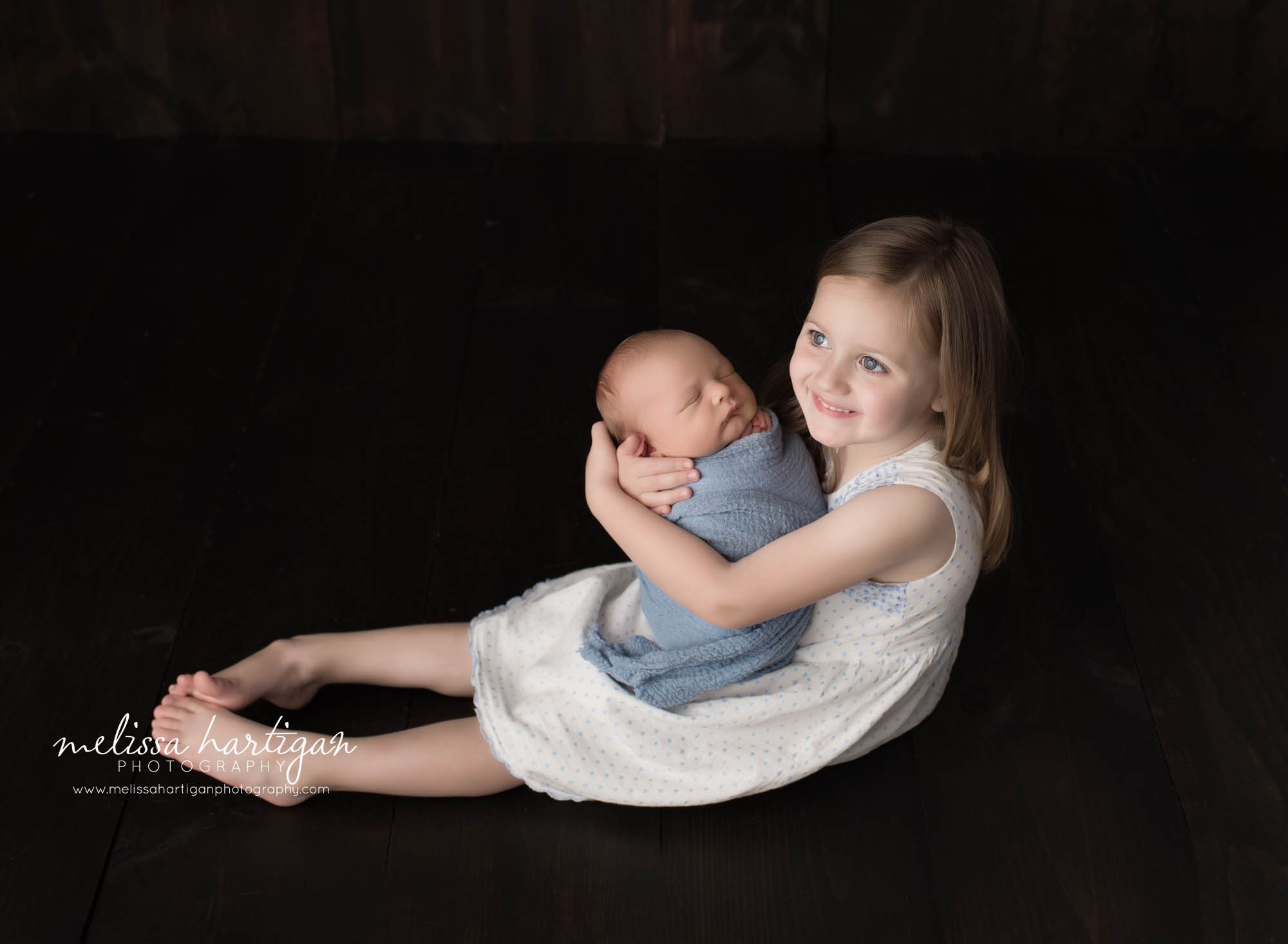 big sister holding newborn baby brother sibling pose family photos hartford county newborn photorgaphy