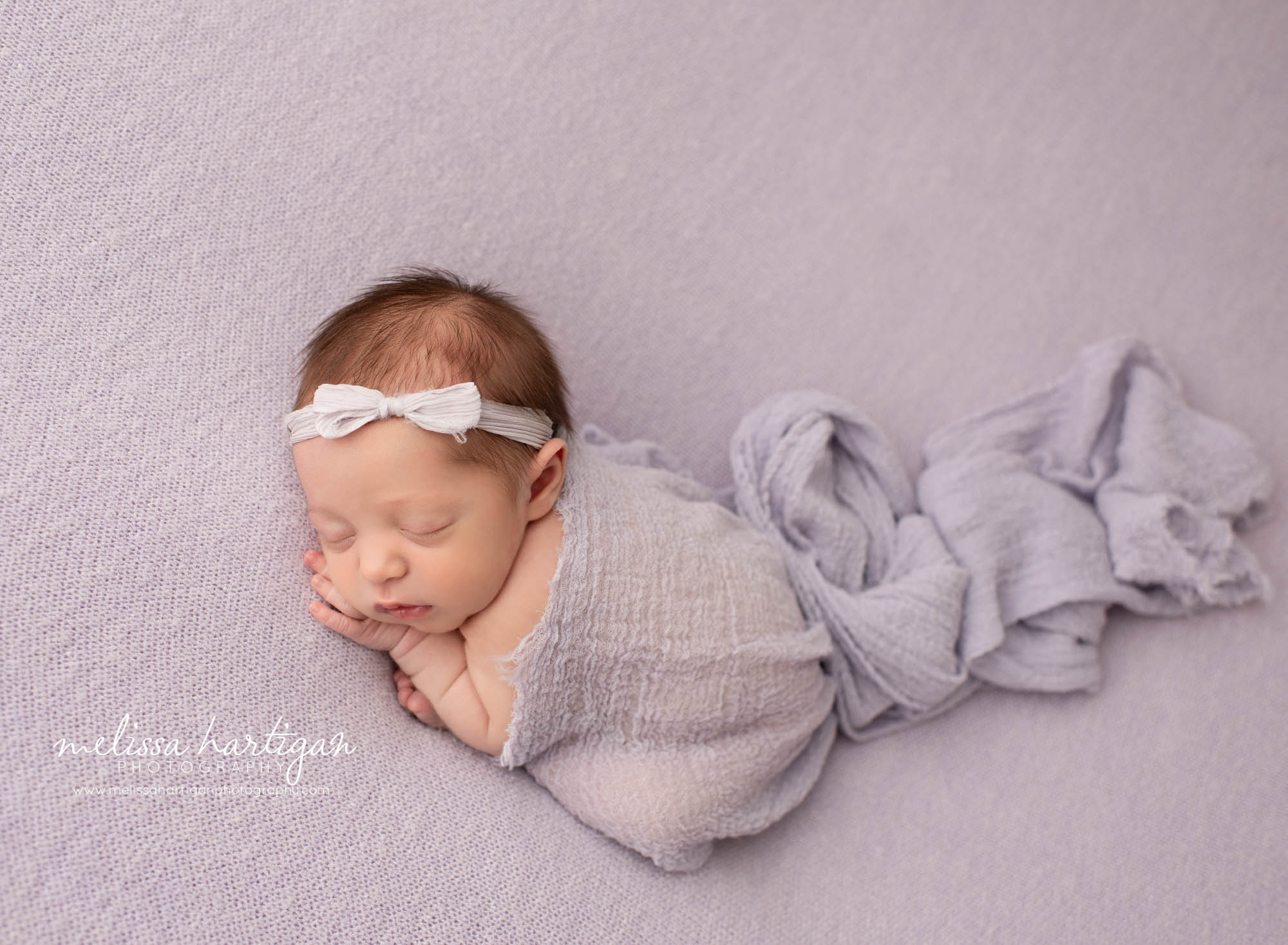 newborn baby girl posed on light purple backdrop baby photography tolland county CT