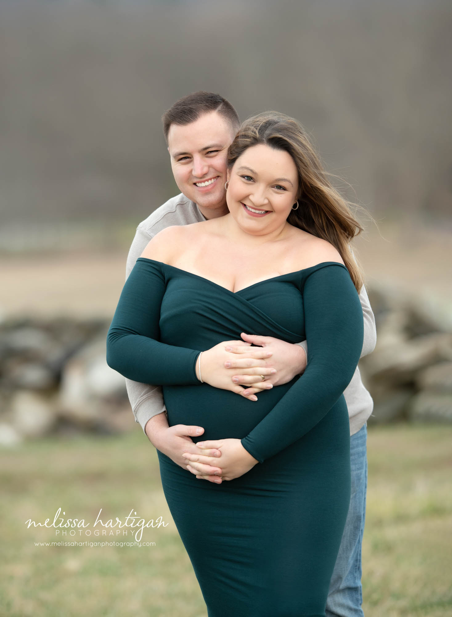 expectant couple holding hands around baby bump smiling happy Connecticut maternity photography