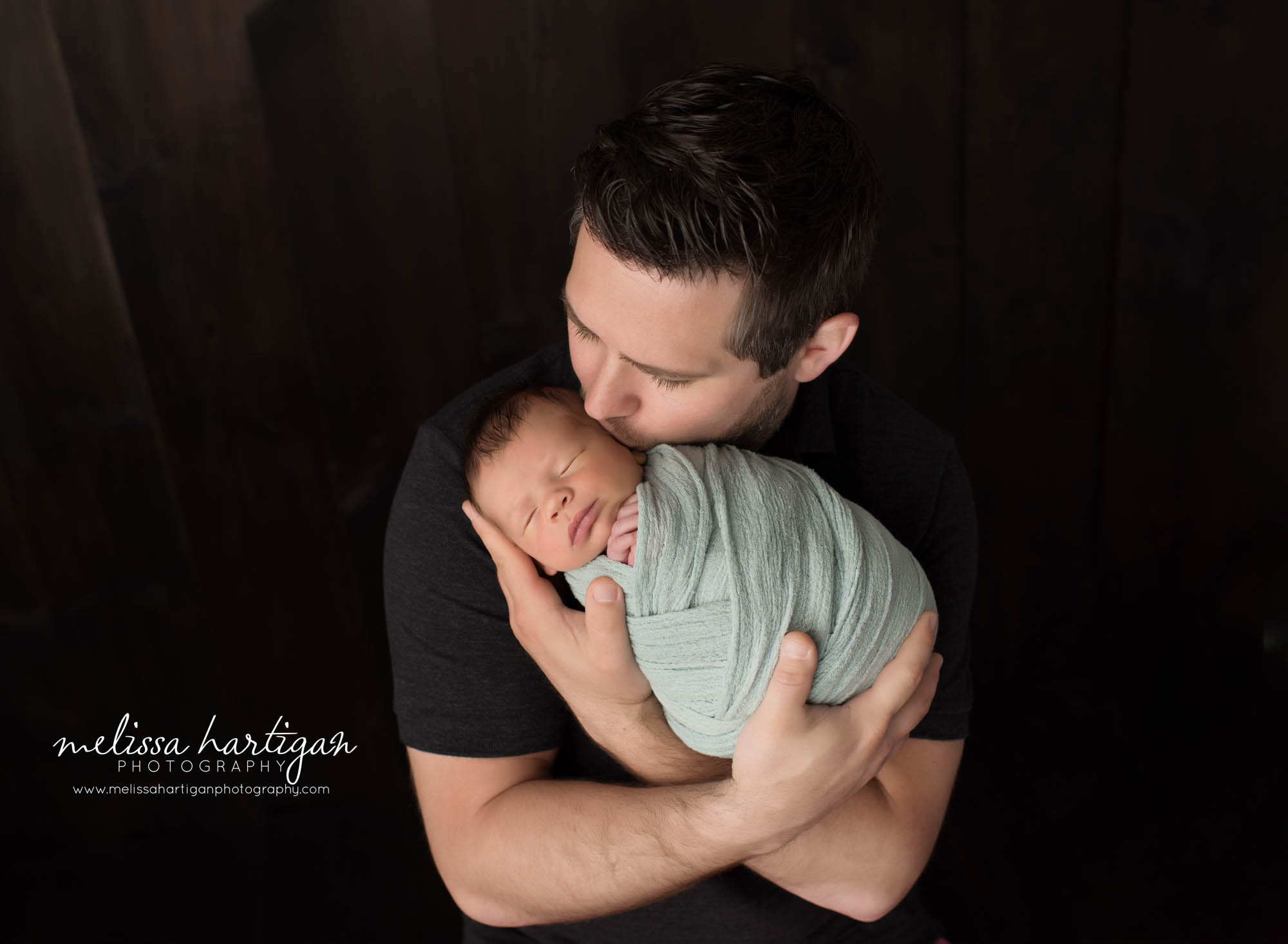 newborn baby boy swaddled in soft green posed with dad for parent pose Avon CT newborn photographer