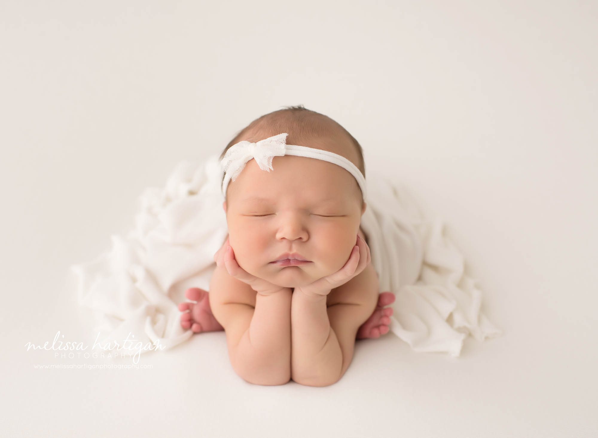 newborn baby girl posed froggy pose studio newborn photo session CT