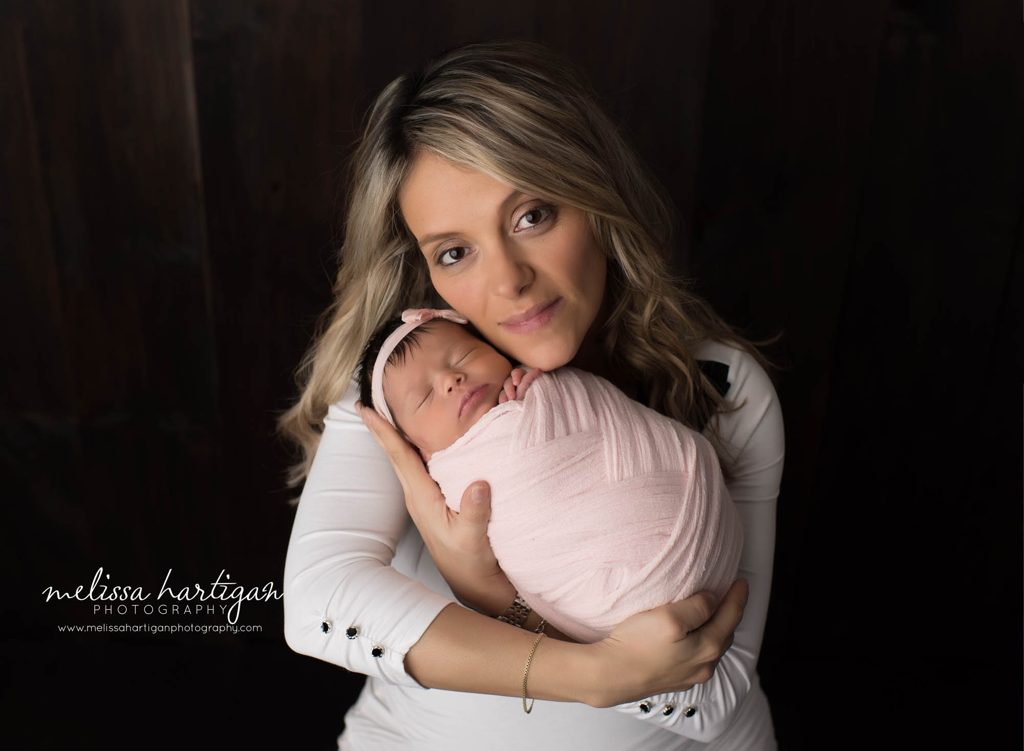 mom holding newborn daughter in parents family pose CT newborn photorgrapher