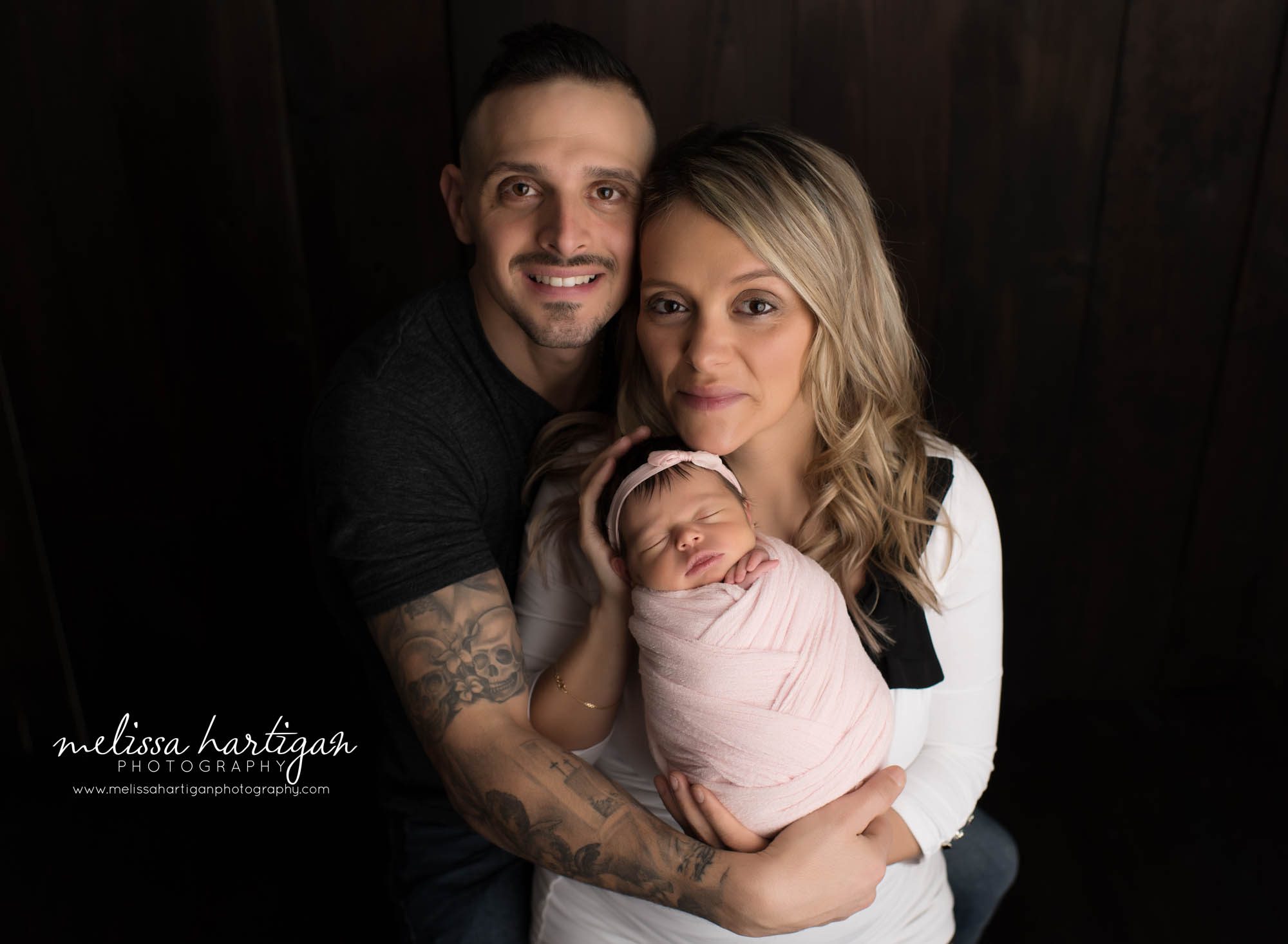 mom and dad holding newborn daughter in parents pose CT newborn photography pictures
