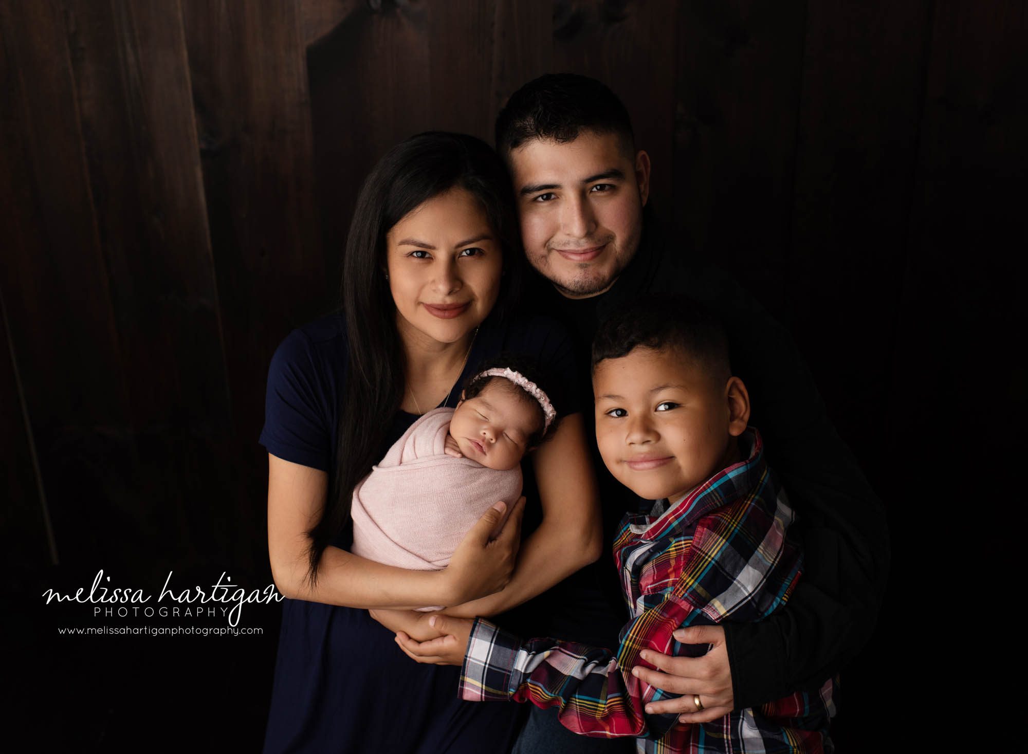 mom dad big brother and newborn baby girl family pose studio newborn photography CT