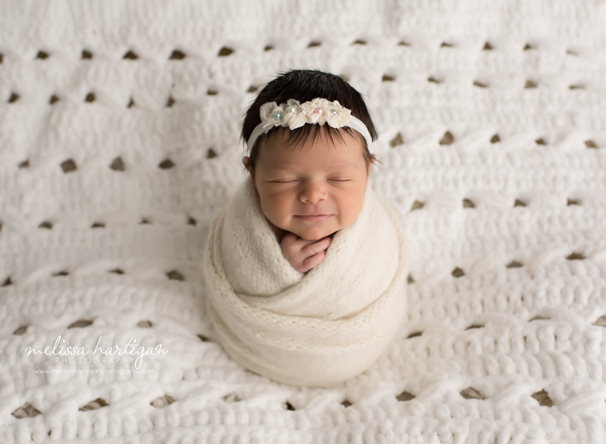 newborn baby girl wrapped in knitted wrap cream color posed on cream backdrop east hartford ct baby photographer
