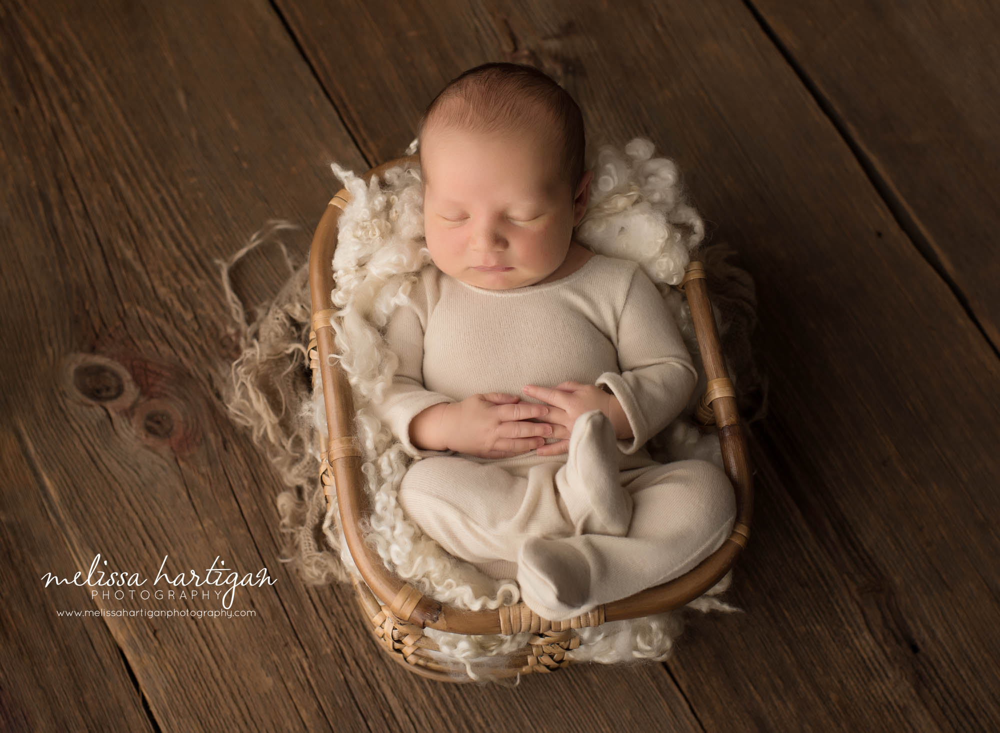 newborn baby boy wearing baby boy outfit posed in wicker basket newborn photographer CT