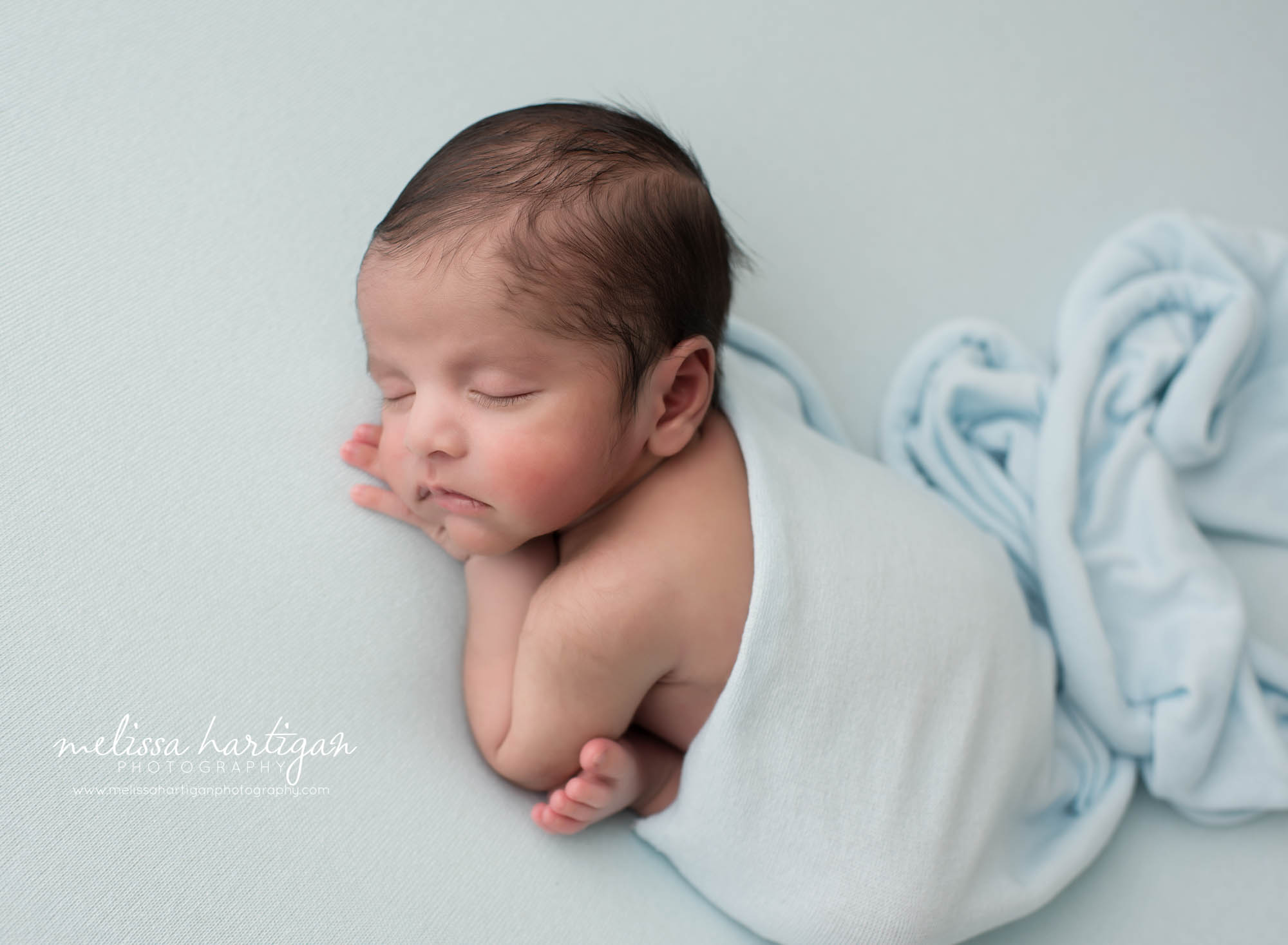 newborn baby boy posed on light blue backdrop modified taco pose newborn photography glastonbury