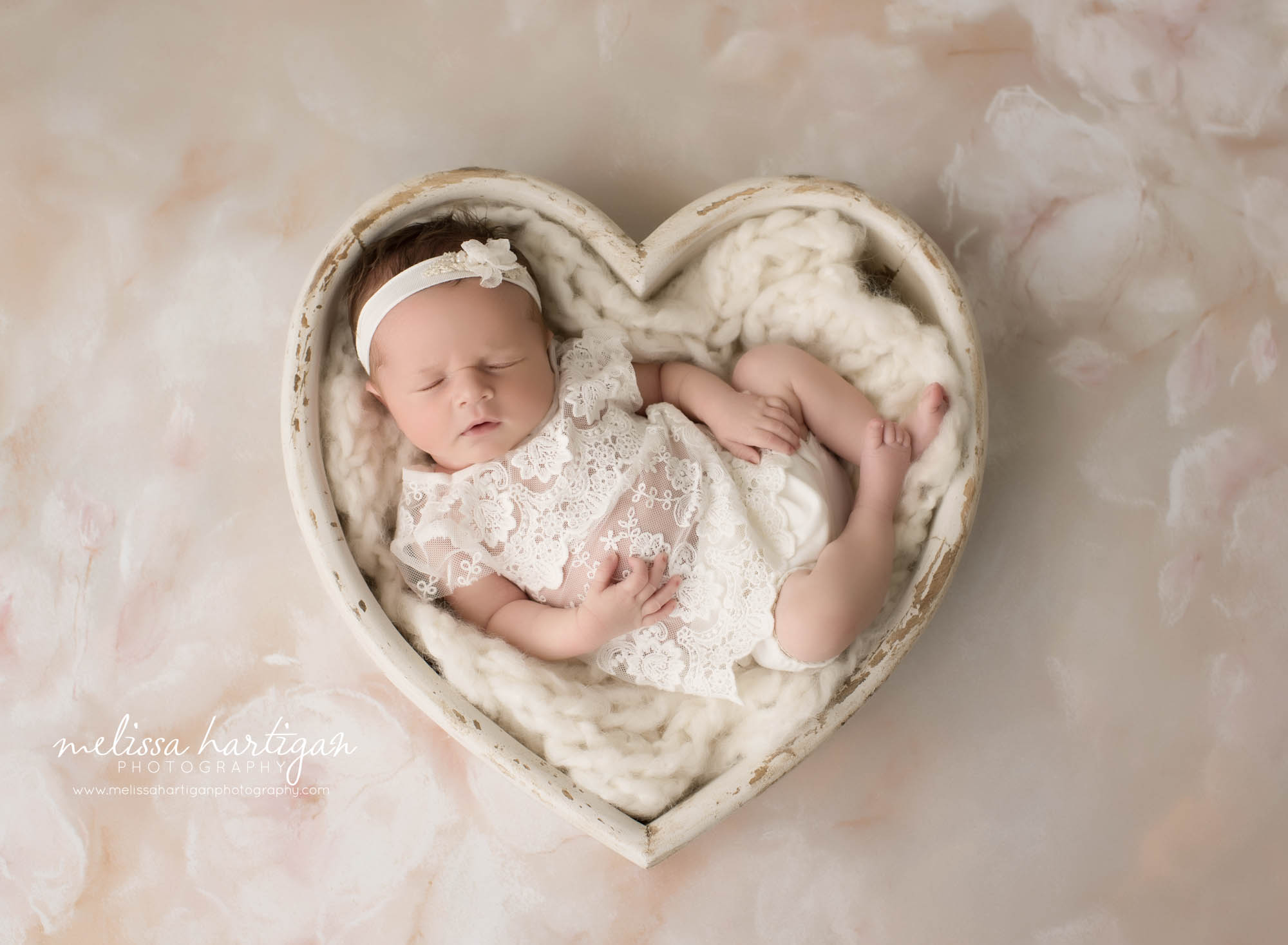 newborn baby girl pose din wooden heart shaped prop newborn photography CT