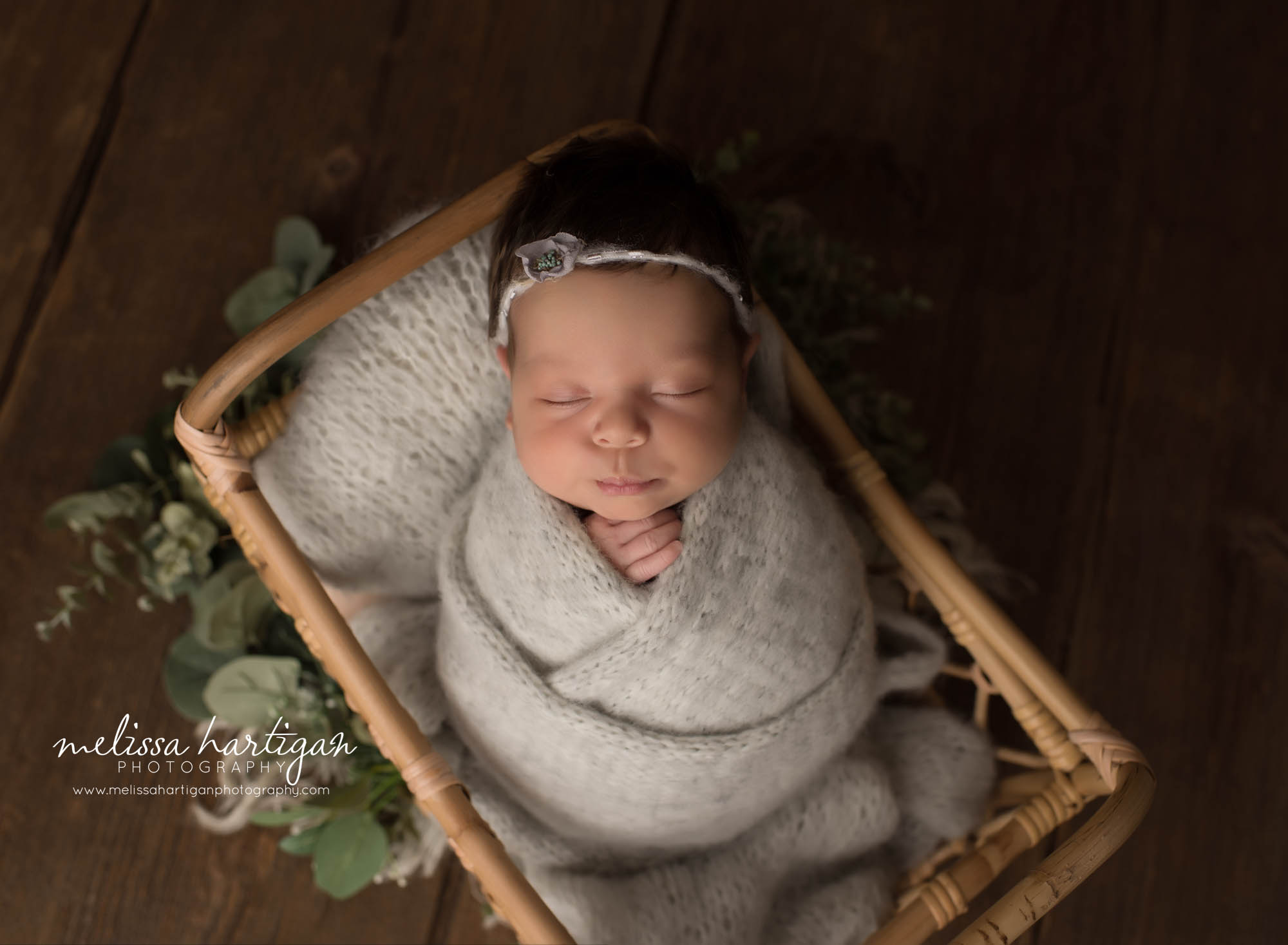 newborn baby girl wrapped in gray knitted wrap wearing headband newborn photographer tolland CT