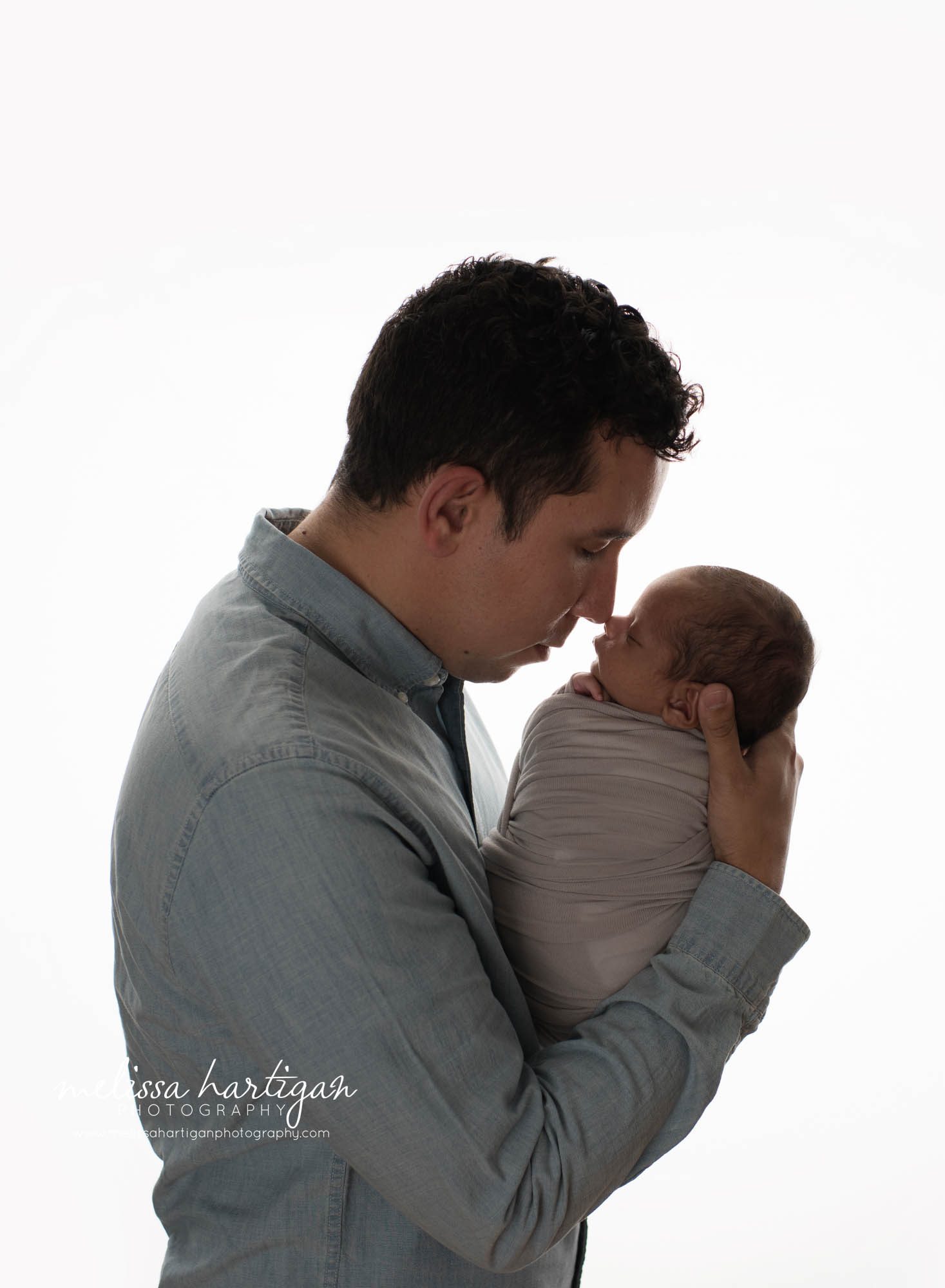 dad holding baby boy studio newborn photography session