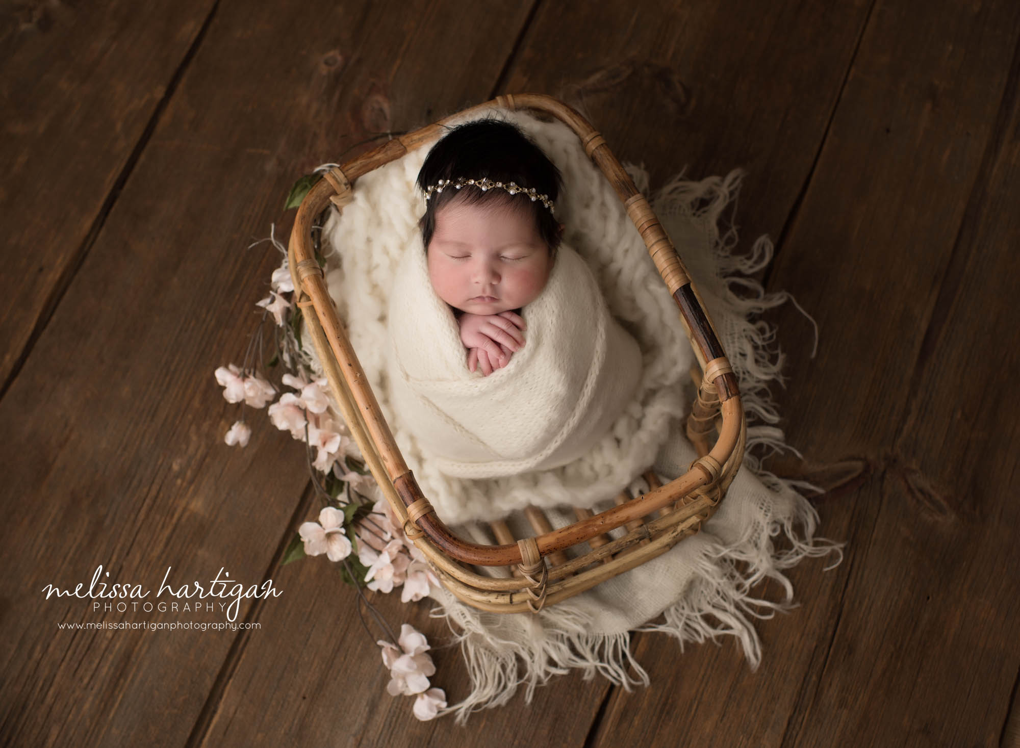newborn baby girl posed in basket with pink cheery blossom flowers ct newborn photography