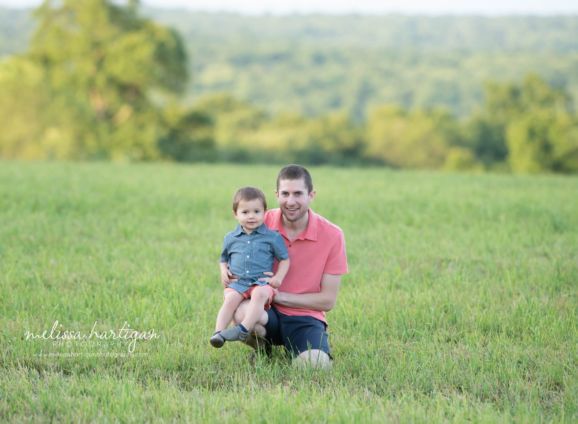 dad with son kneeling in grass outdoor family photography CT