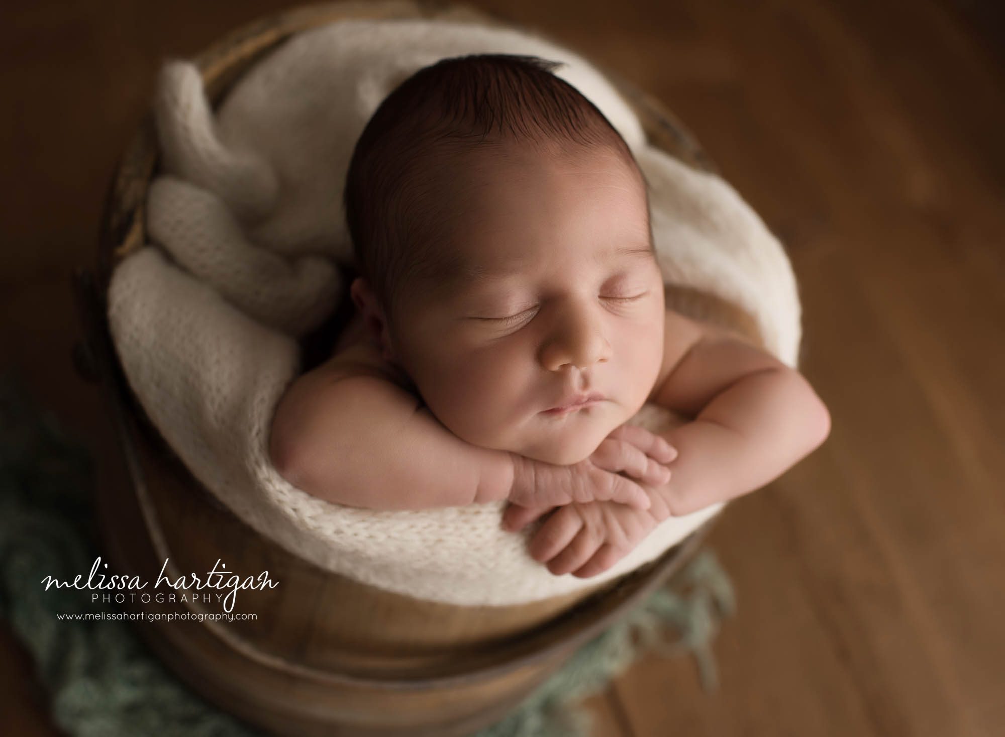 newborn baby boy pose din wooden bucket with cream layer wrap newborn photography CT
