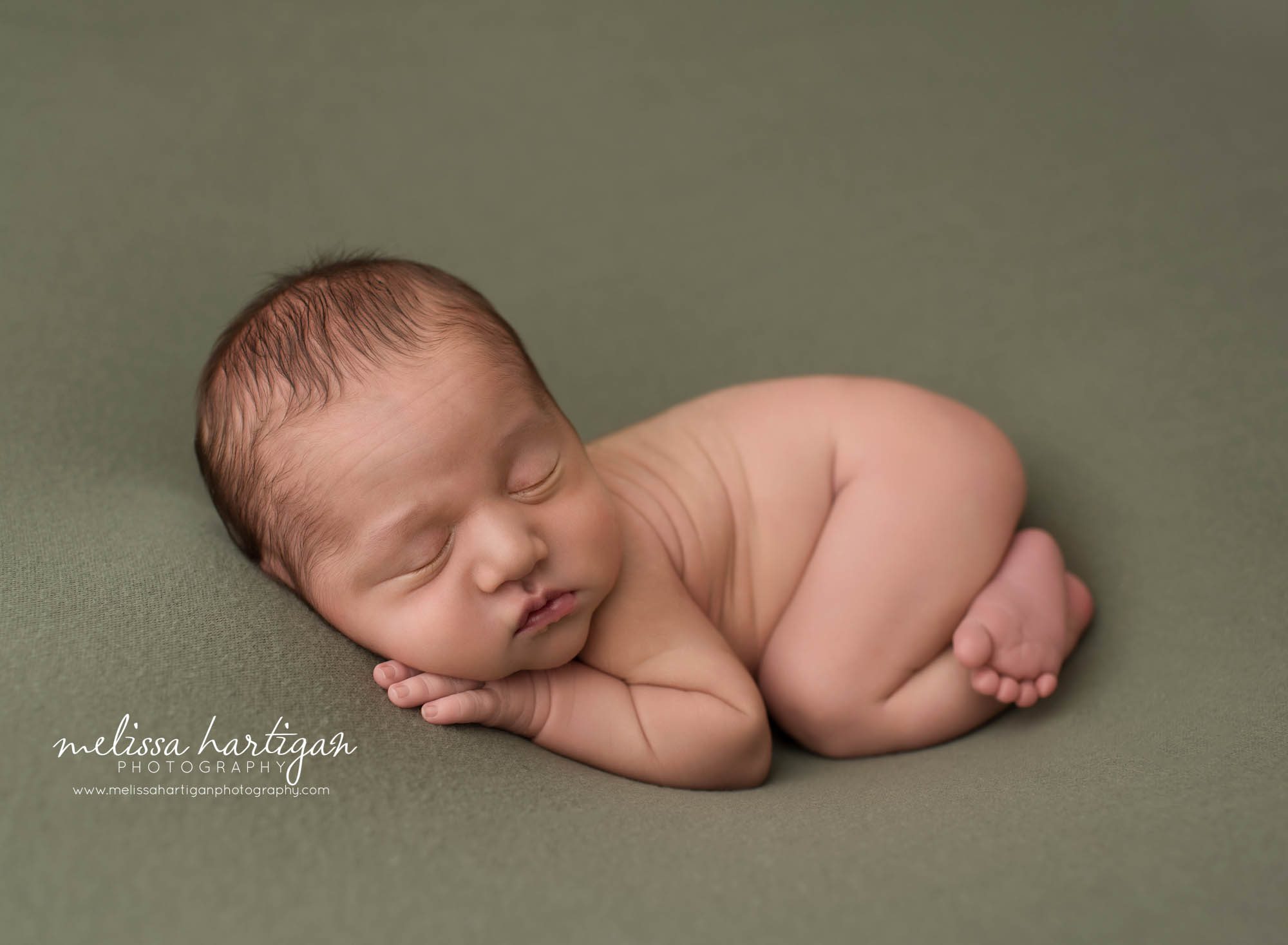 newborn baby boy posed on tummy on sage green backdrop newborn photographers Griswold CT