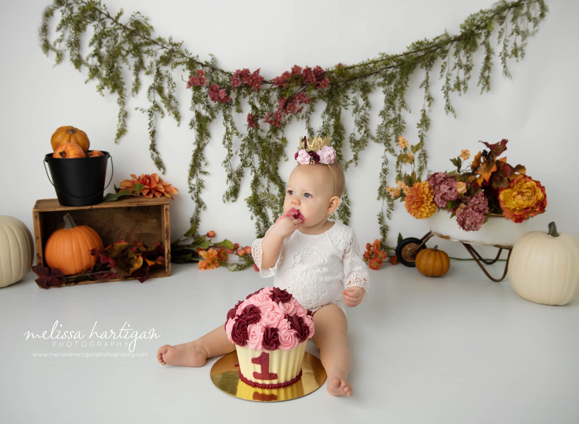 baby girl eating cake for first birthday photography session CT baby photographer