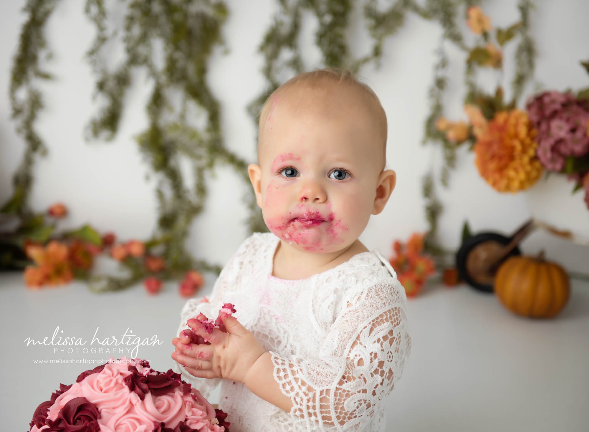baby girl with icing on her face cake smash photography CT