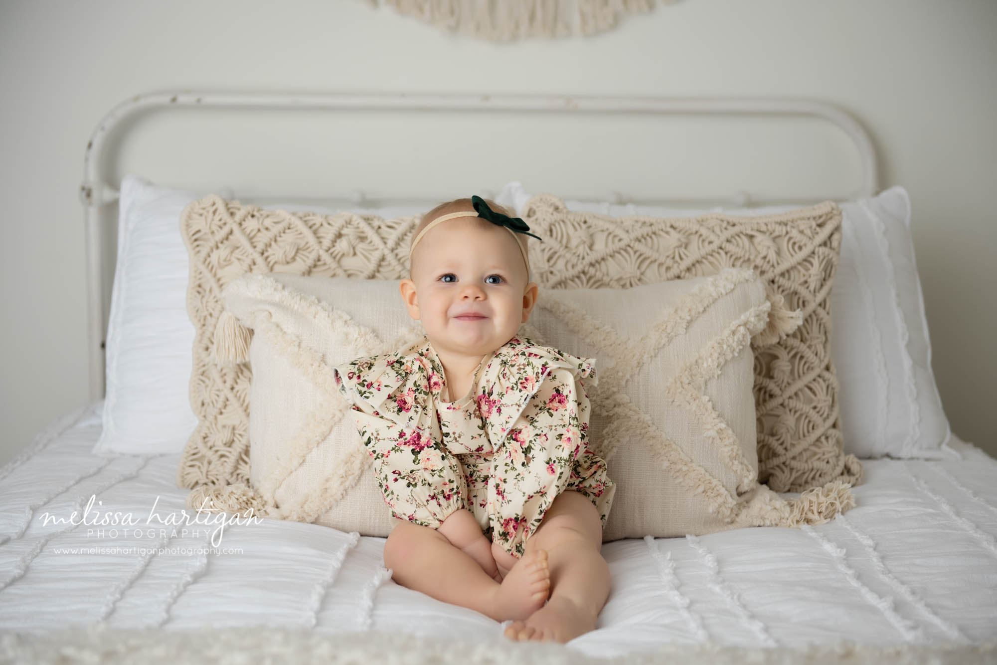 baby girl sitting on bed in studio milestone photography CT