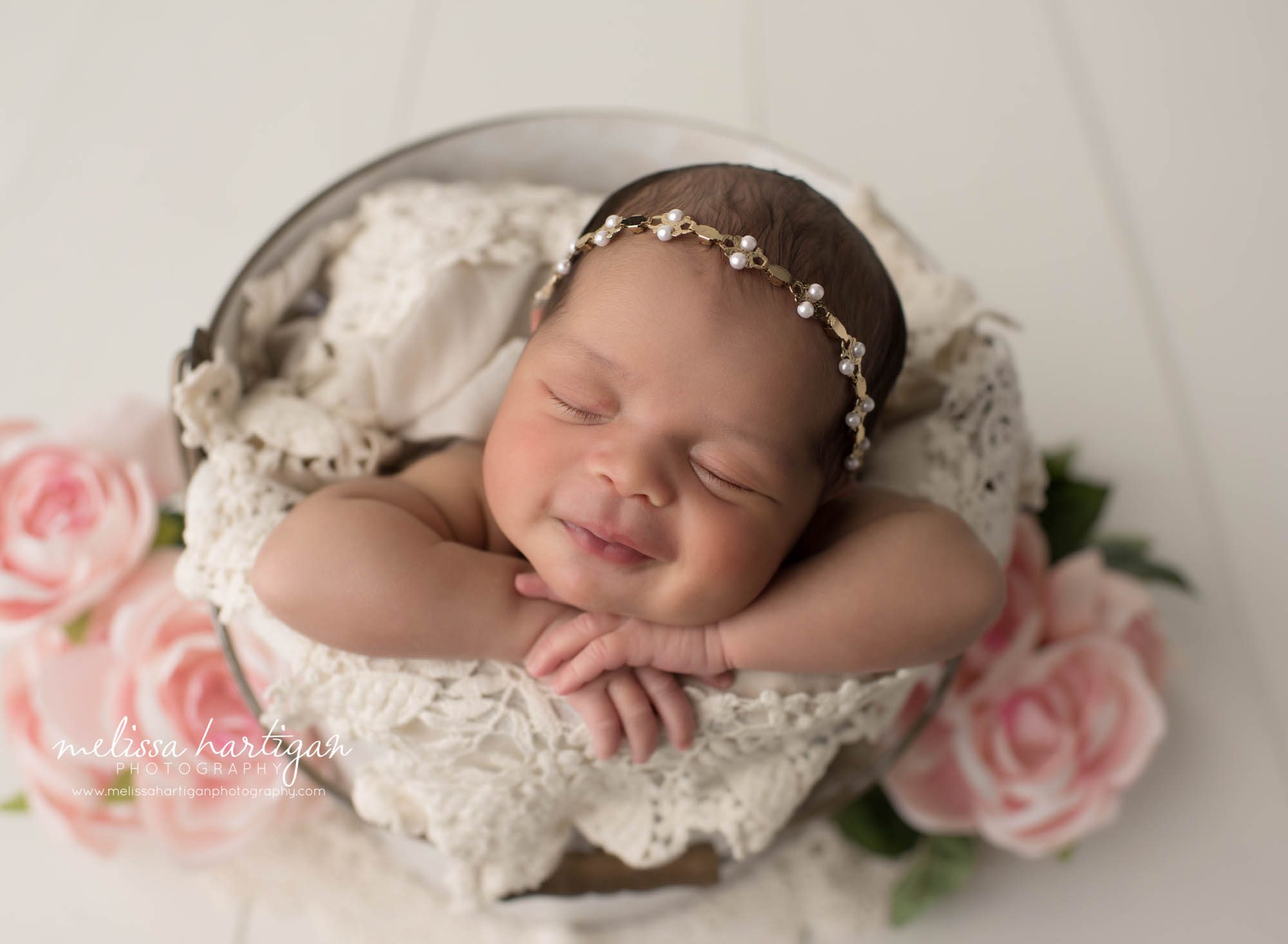 newborn baby girl posed in bucket smiling CT newborn photography session