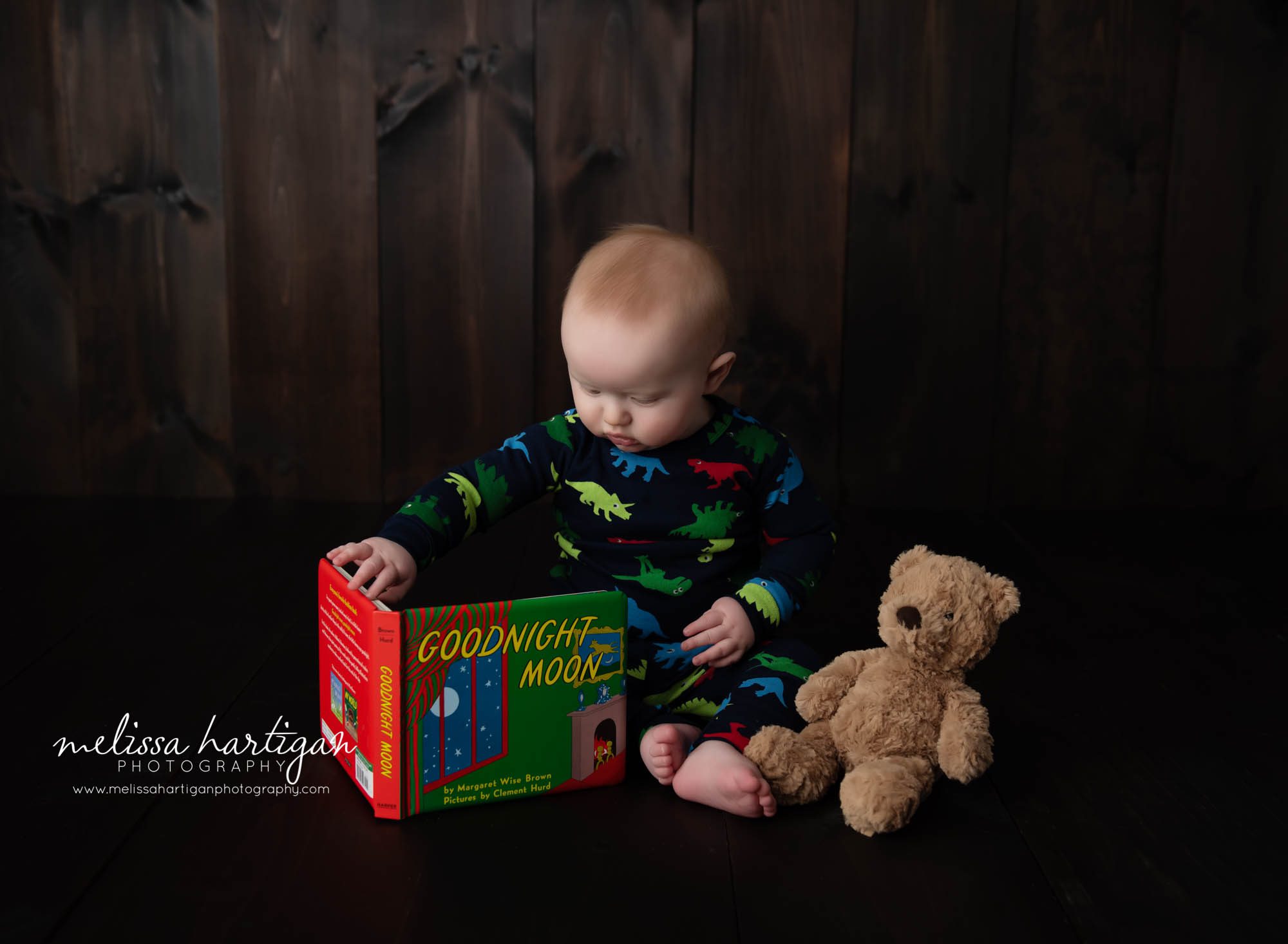 baby boy looking at baby book with teddy bear beside him glastonbury baby photography