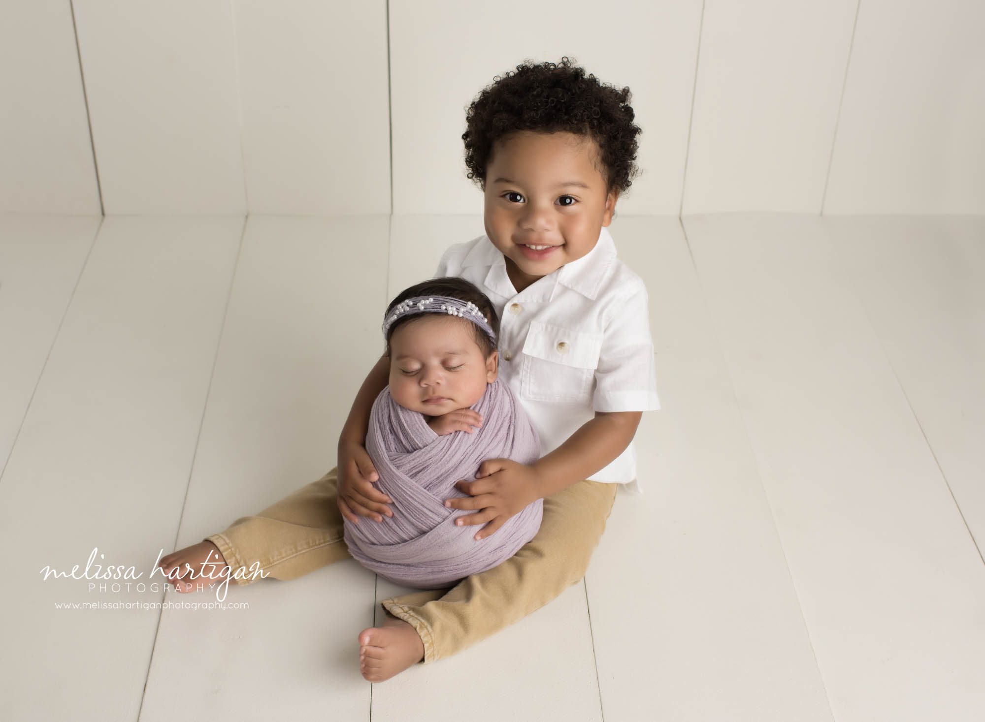 big brother holding new baby siter sibling pose newborn photography new haven county CT