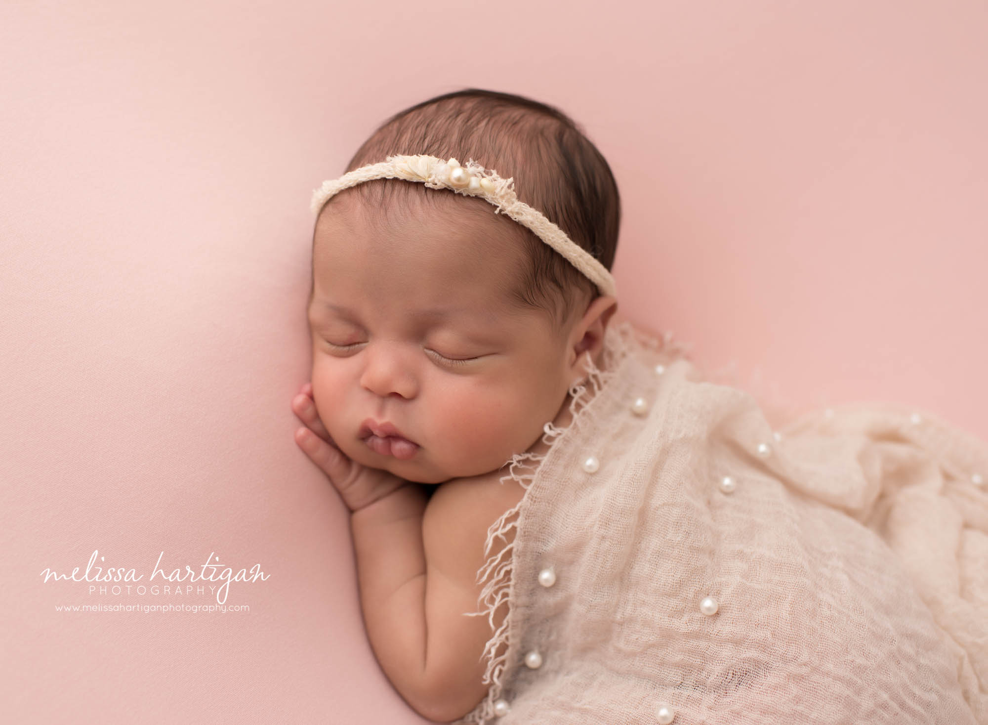 newborn baby girl posed on side with beaded layer draped over wethersfield CT newborn photography