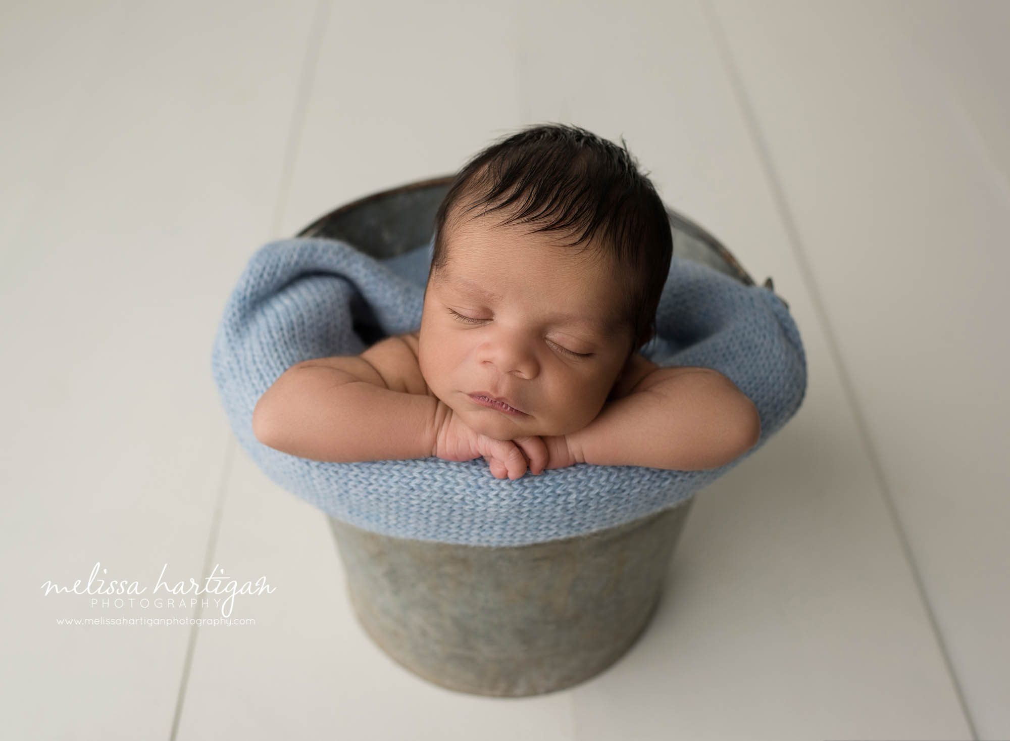 newborn baby boy posed in bucket