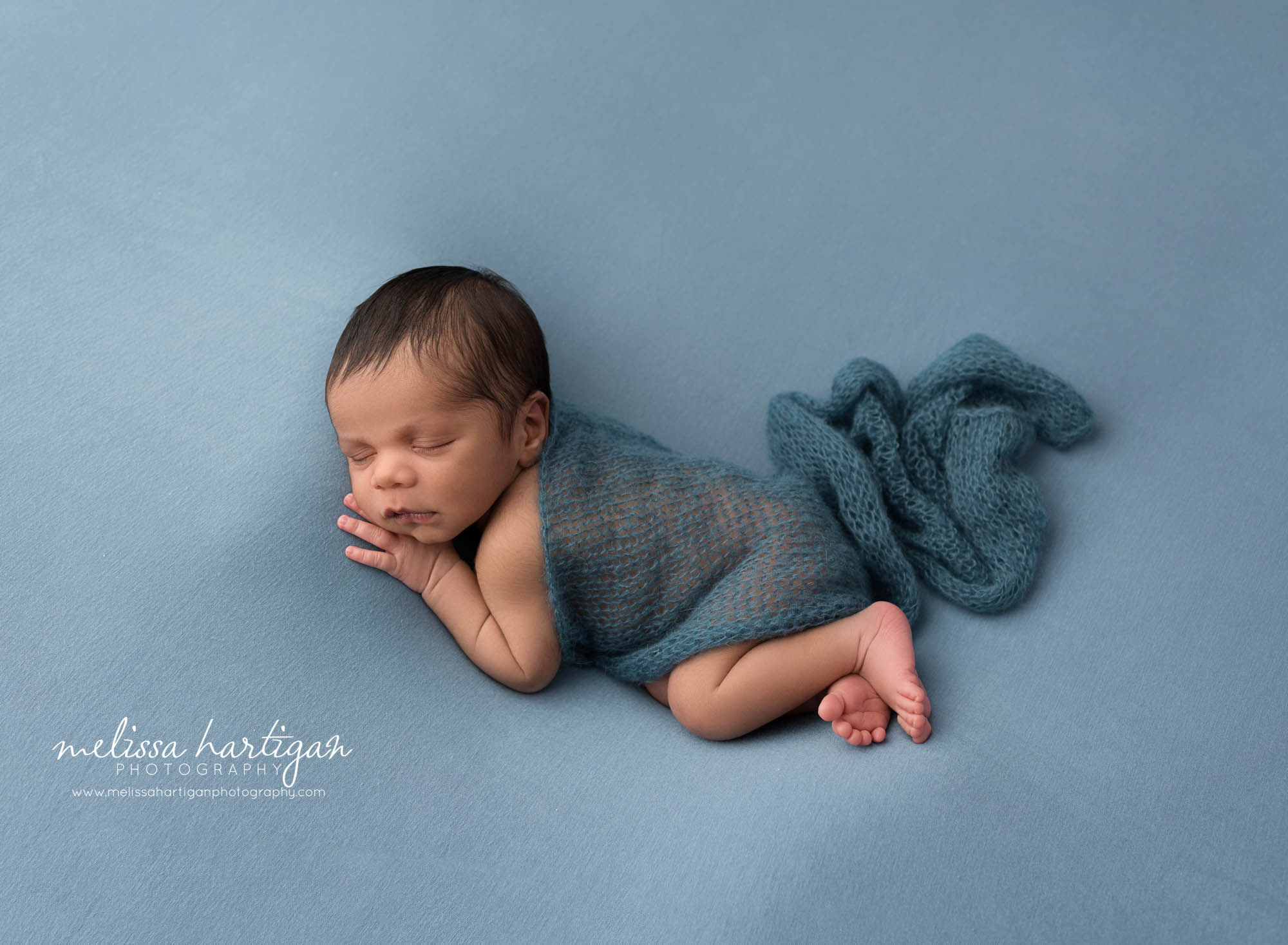 newborn baby boy posed on blue backdrop rocky hill newborn photography