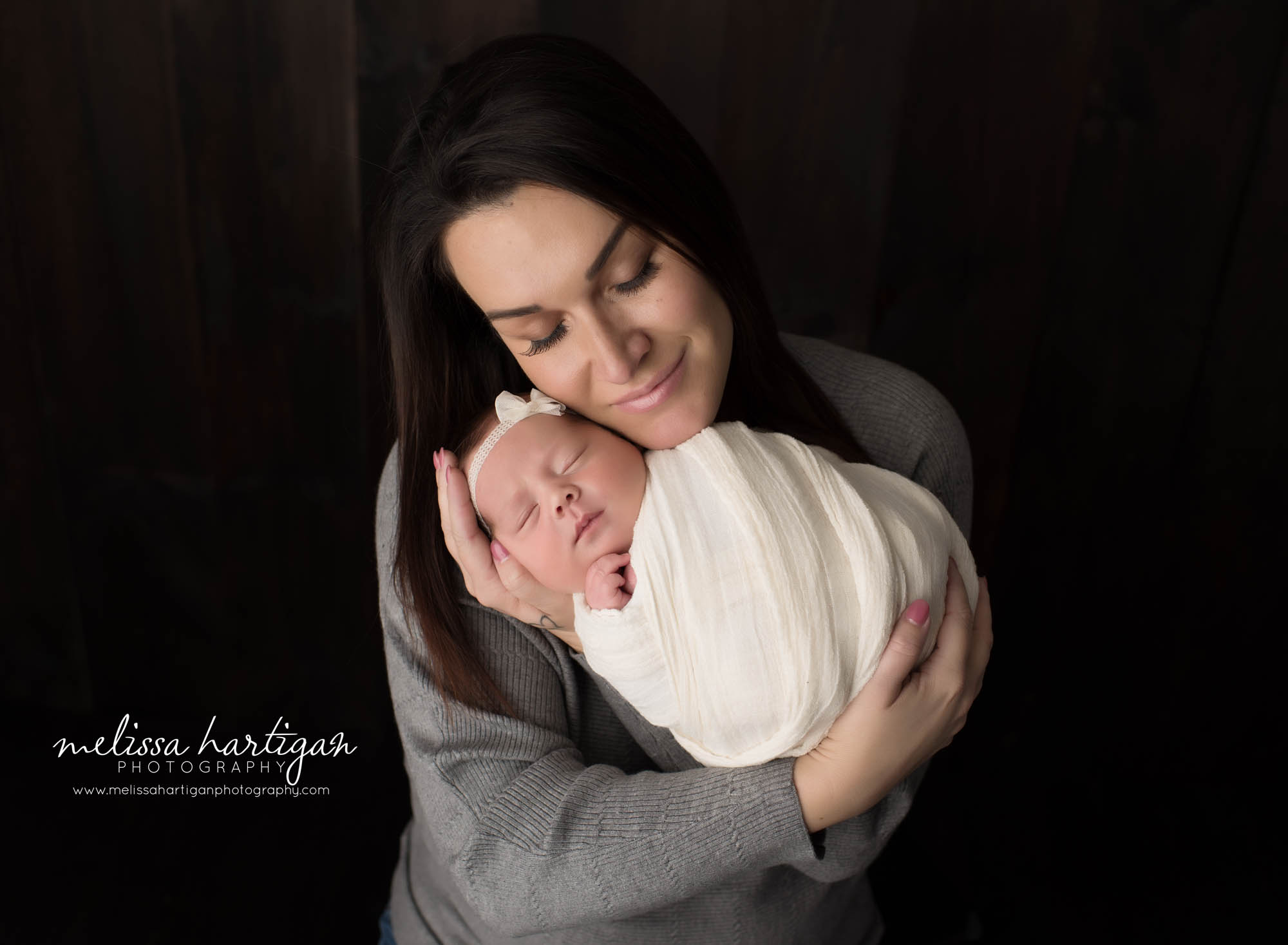 mom holding newborn daughter mom pose connecticut newborn photographers