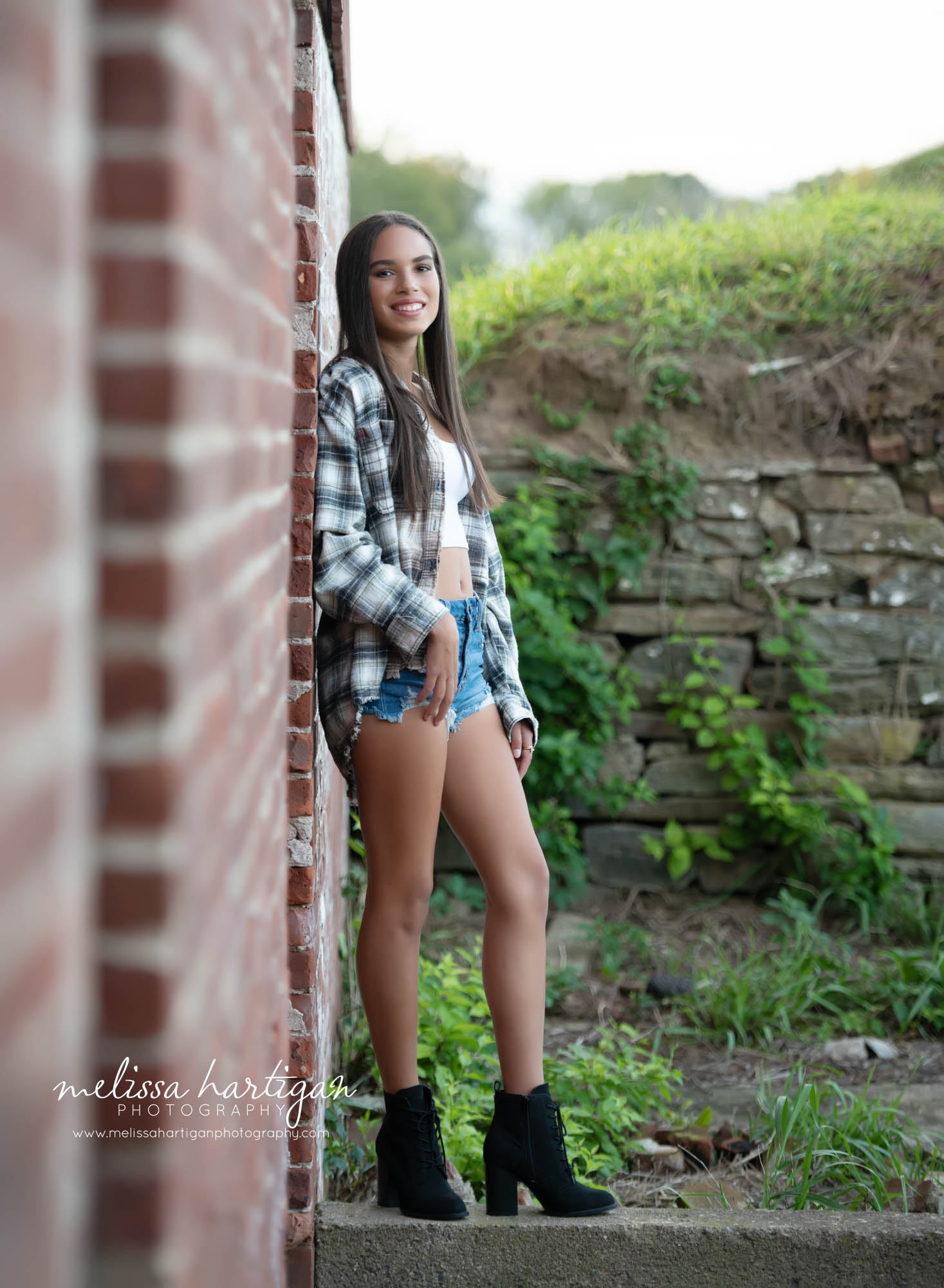 senior high school girl leaning against brick wall tolland county senior photography photoshoot