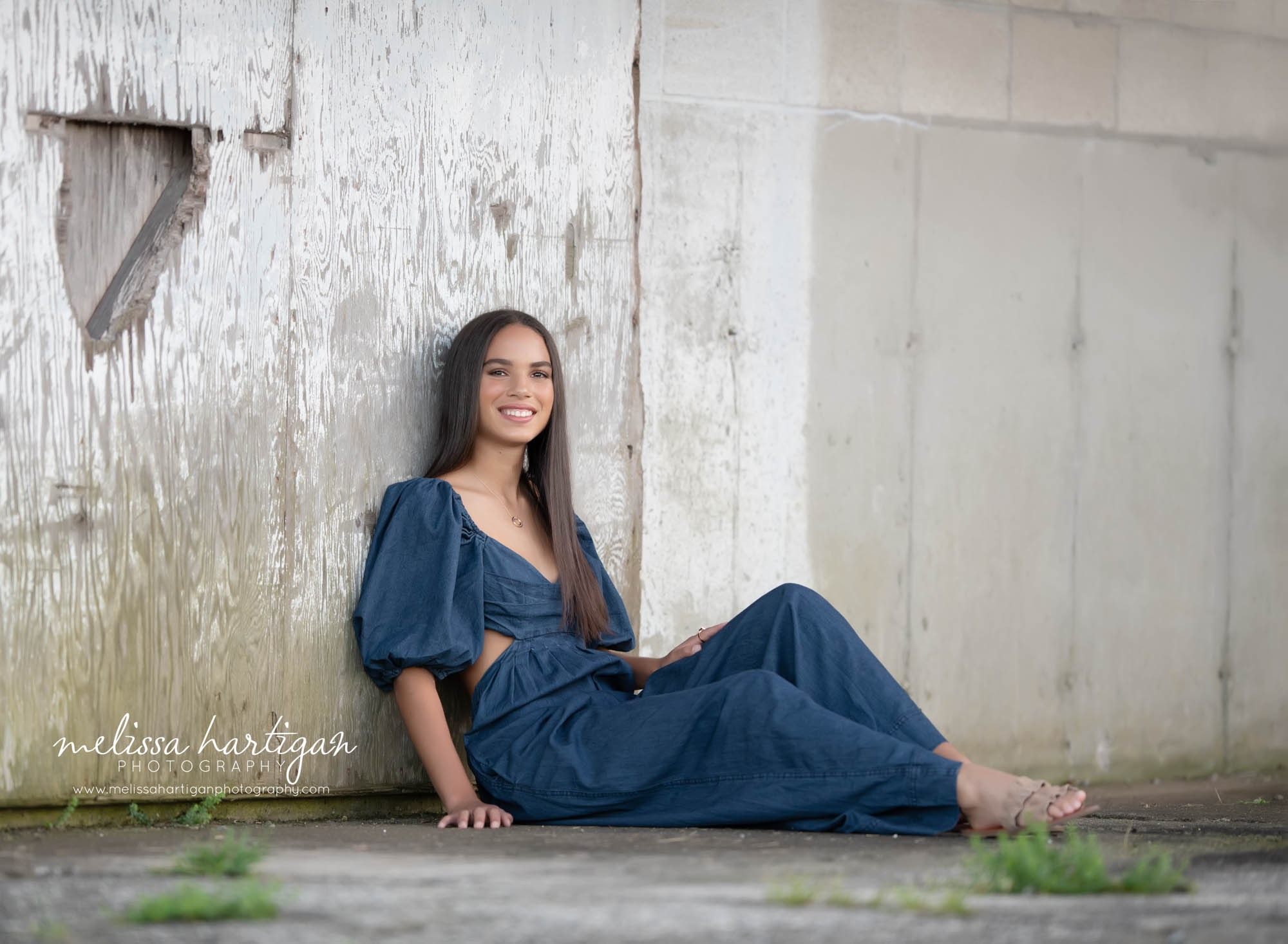 girl wearing blue outfit sitting leaning against wall gradation portrait photoshoot