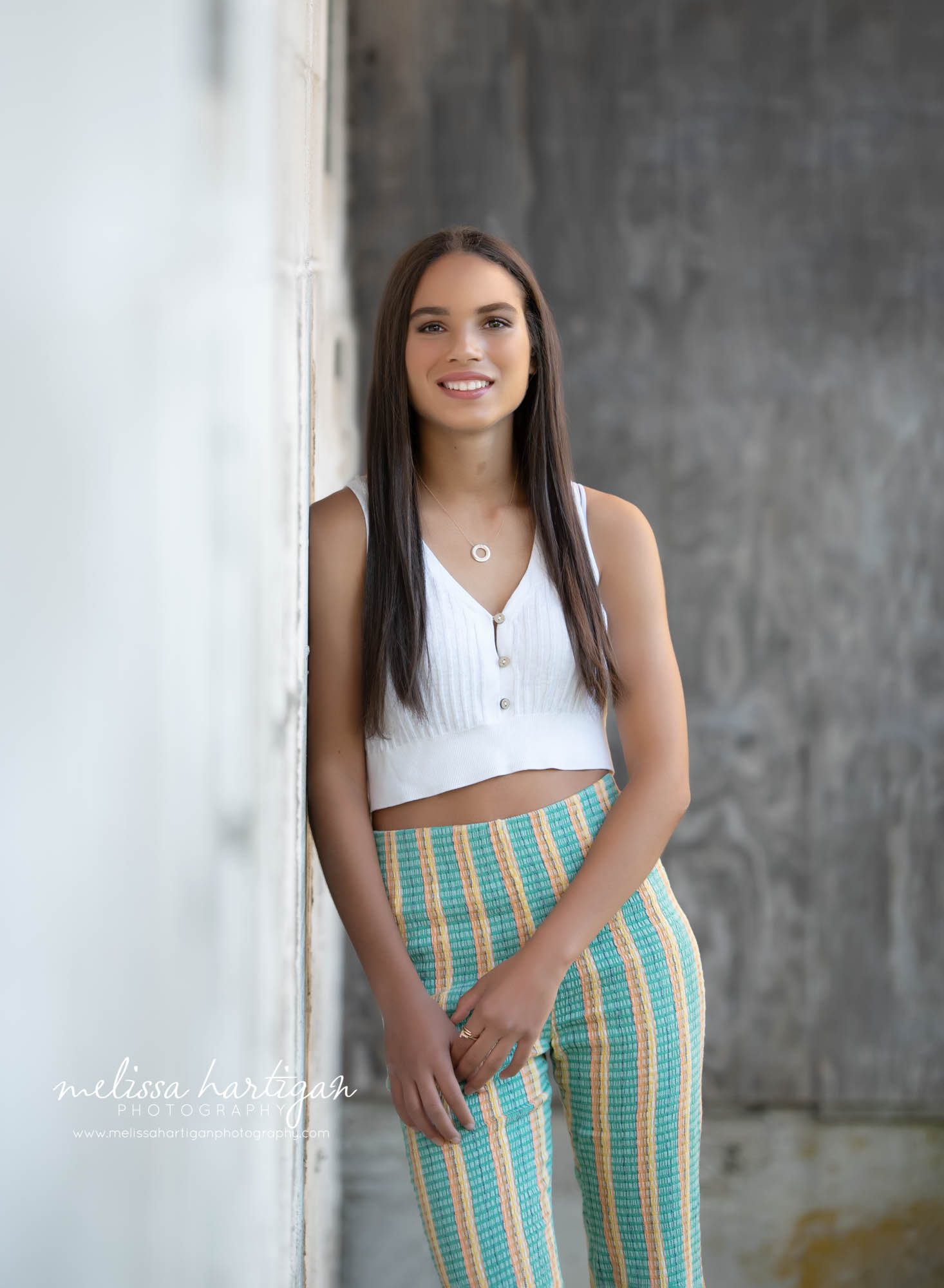 senior high school girl standing next to wall senior photography tolland county