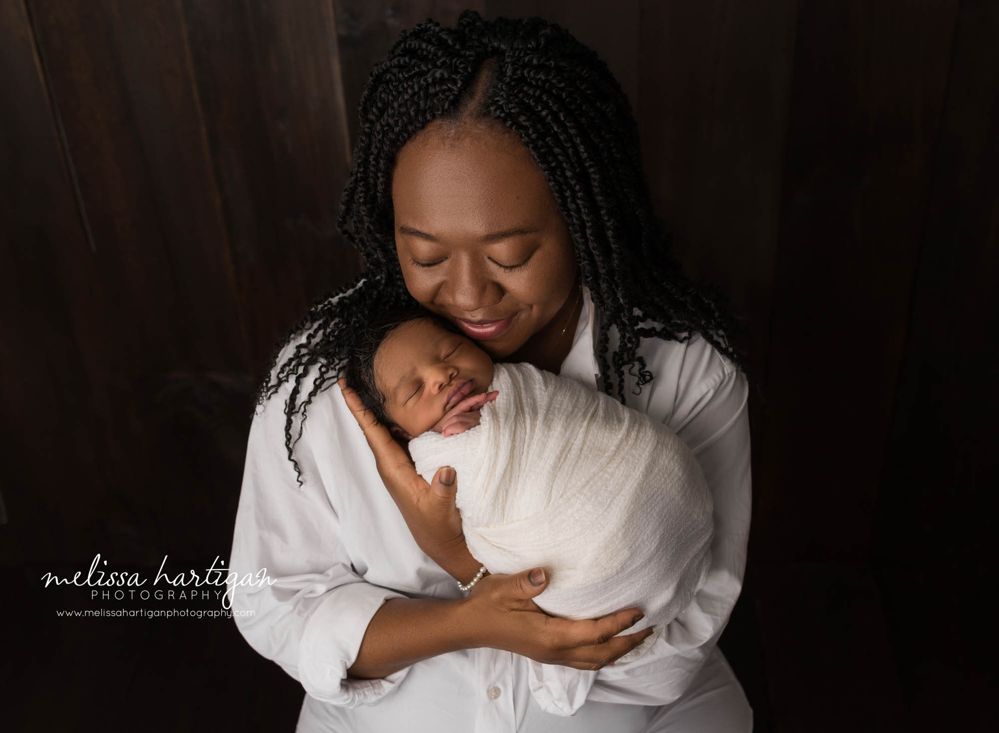 mom holding newborn son parent pose Connecticut newborn photography
