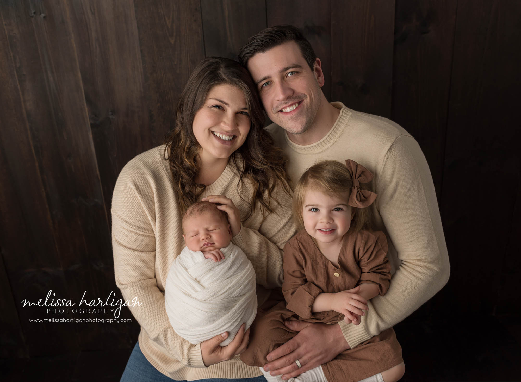 mom dad big sister and newborn baby boy family pose captured in CT studio