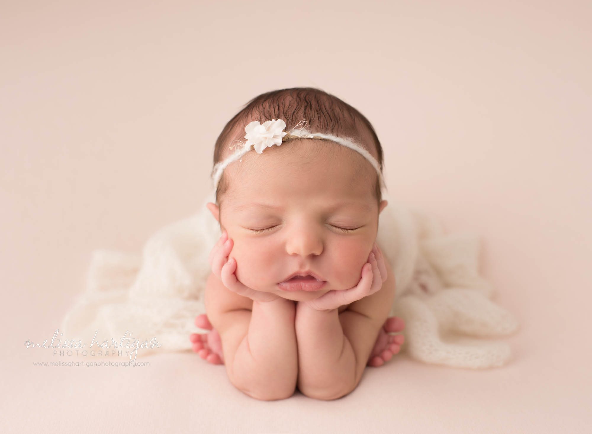 baby girl posed on pink backdrop posed froggy pose newborn photography Massachusetts