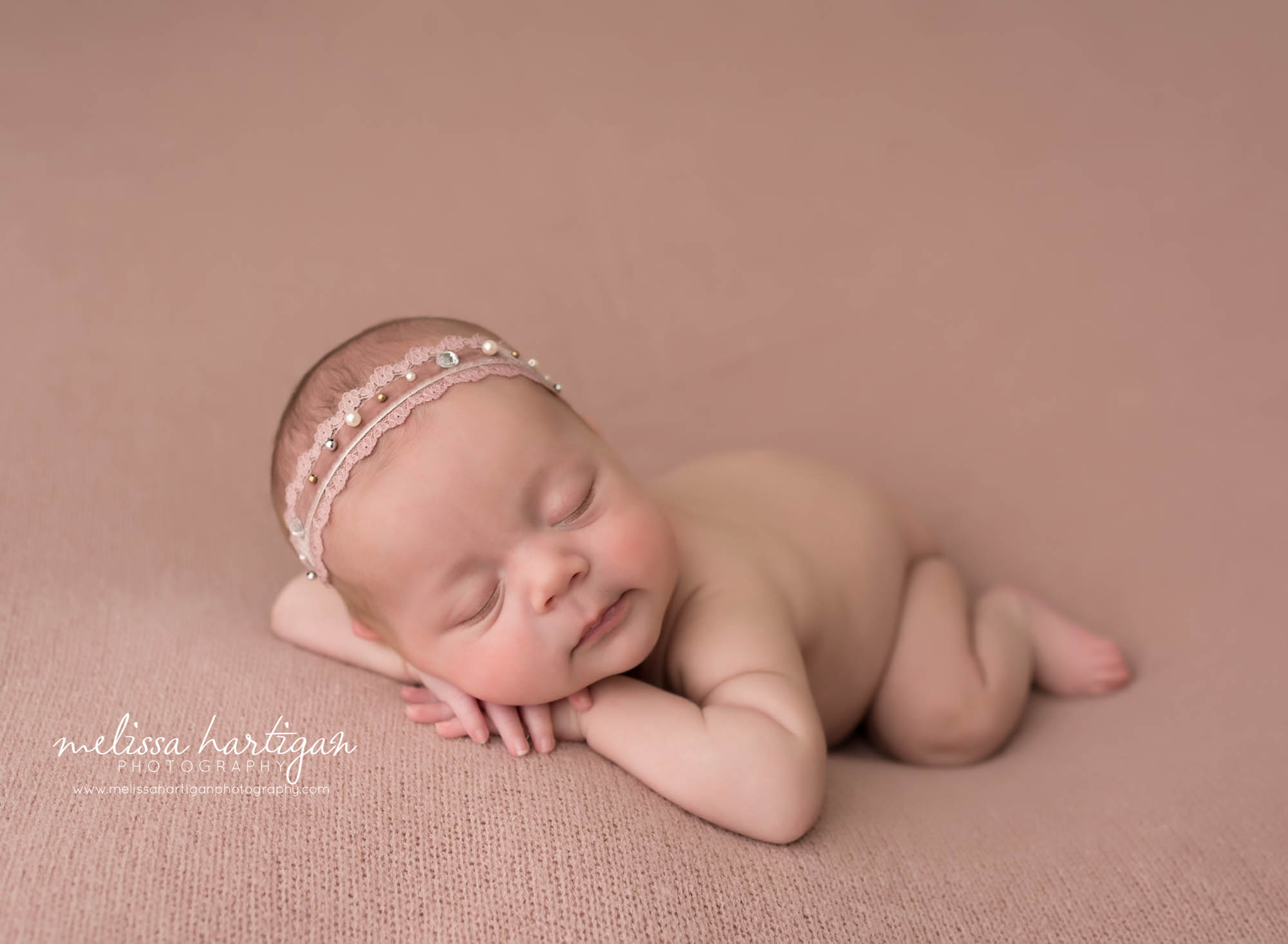 newborn baby girl posed on tummy with head on hands stafford CT newborn photography