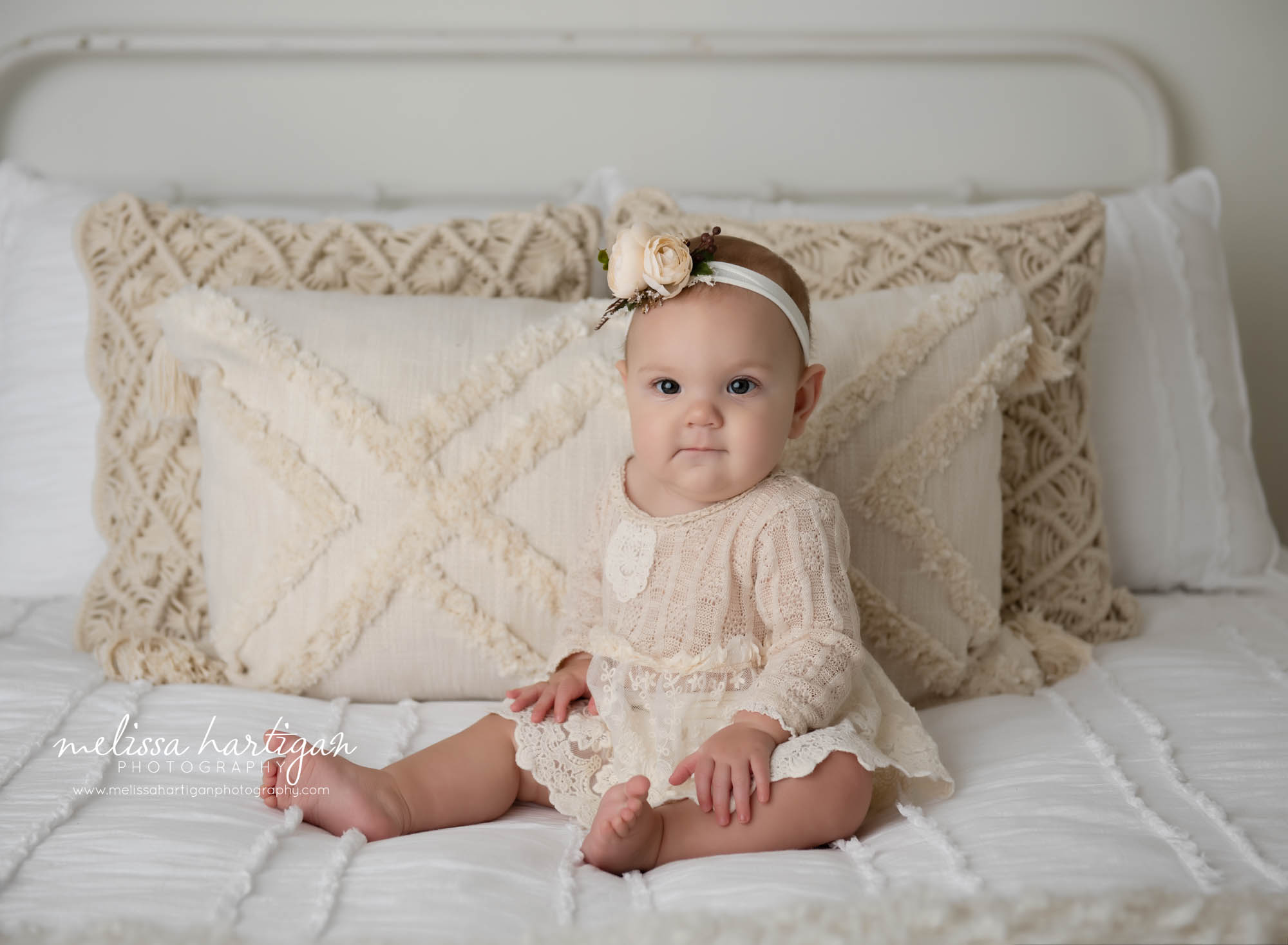 baby girl sitting on bed in CT photographer studio