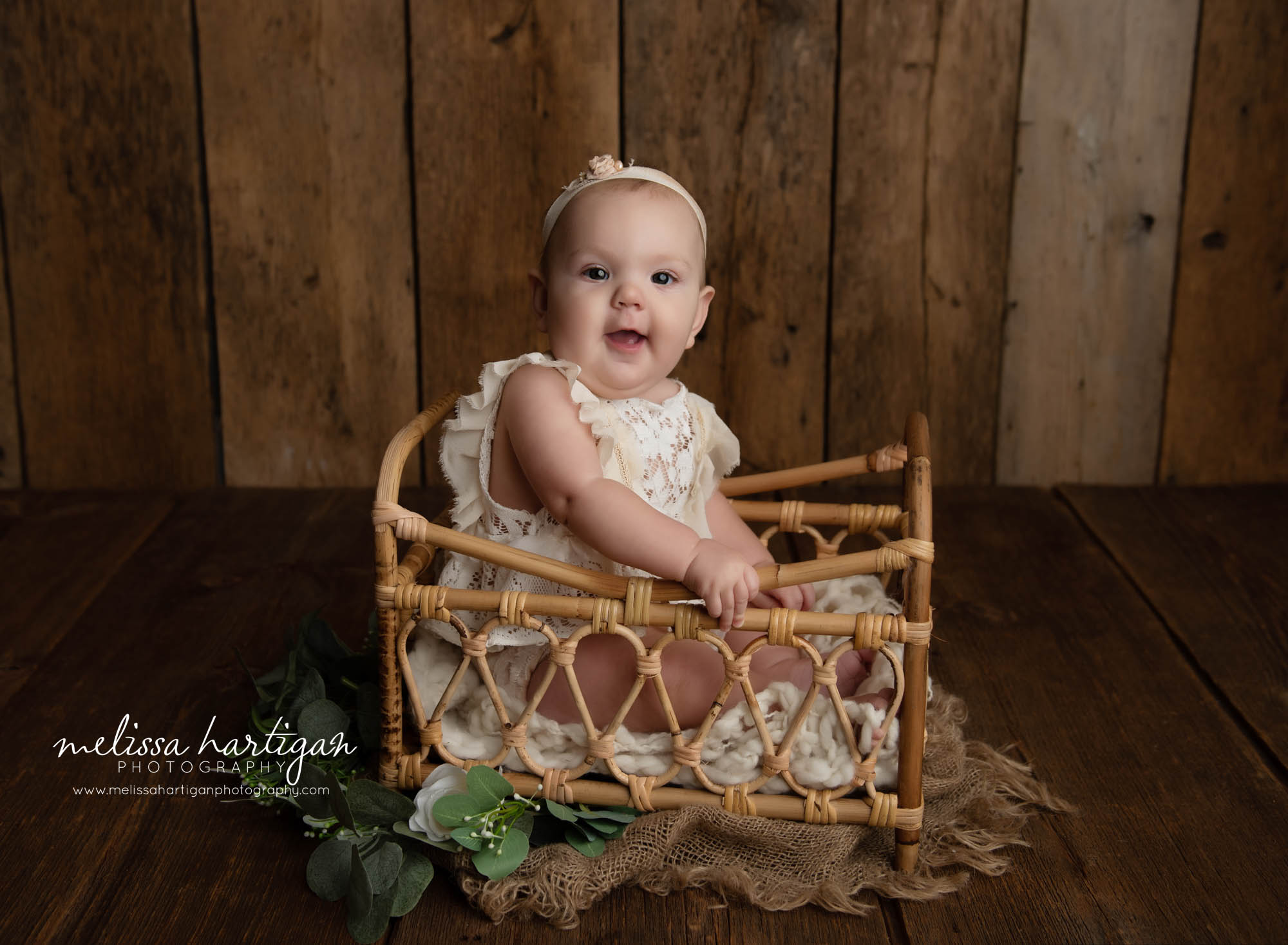 baby girl sitting in basket sitter milestone session