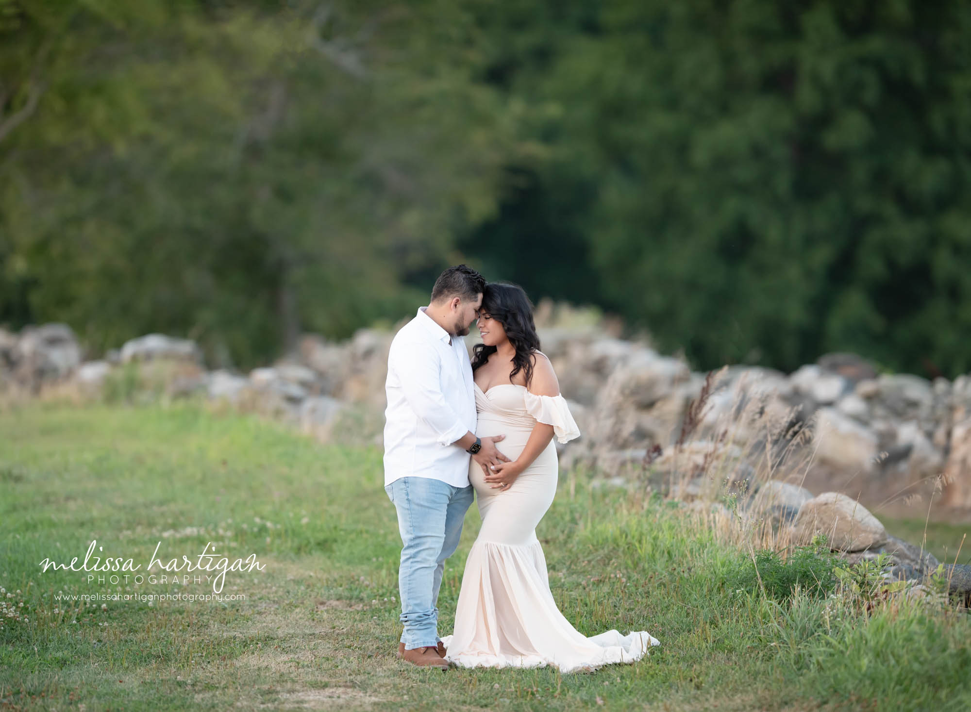 couples pose foreheads together holding baby bump maternity photography CT