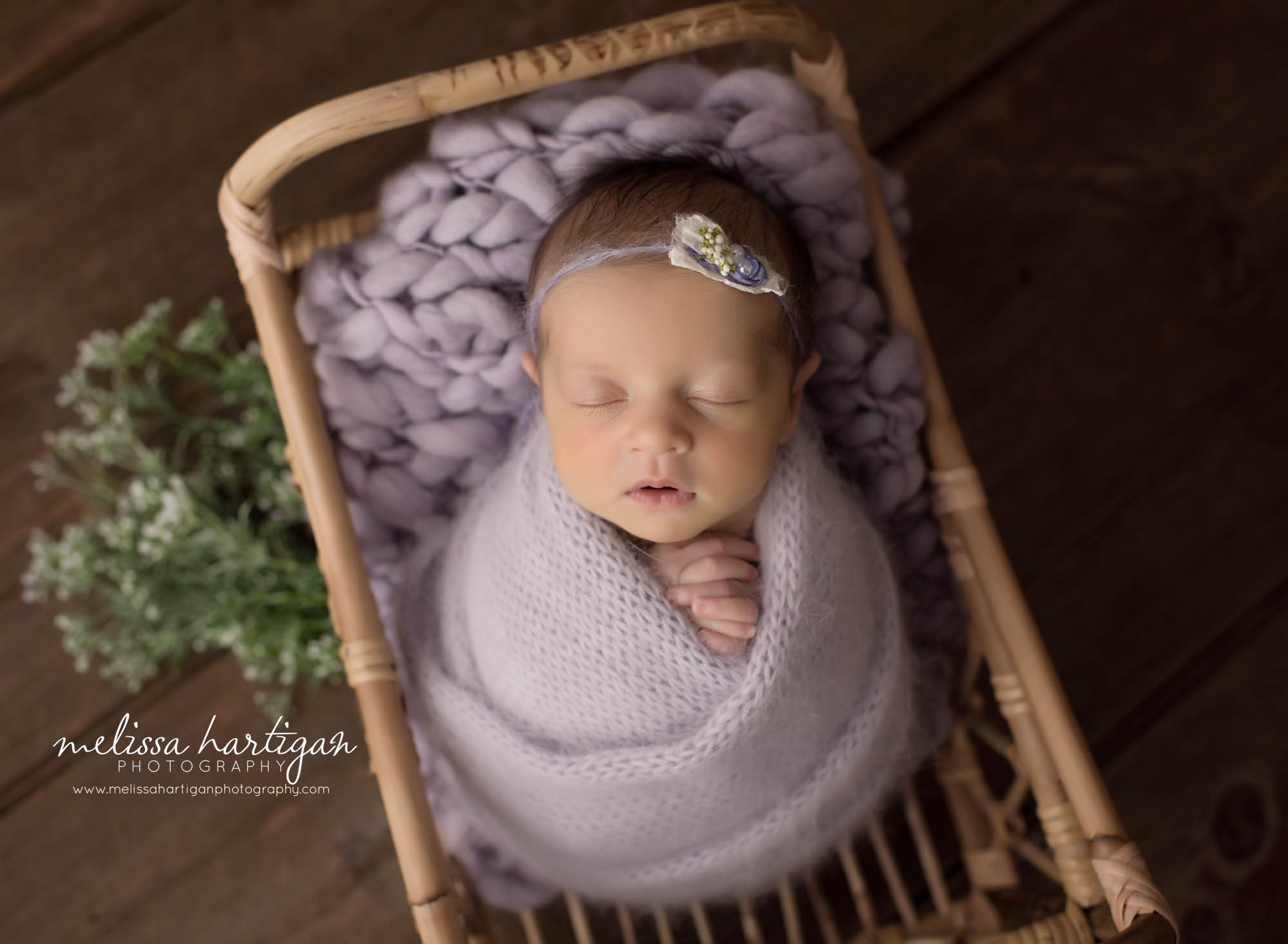 newborn baby girl wrapped in light purple color knitted wrap posed in basket newborn photographer CT