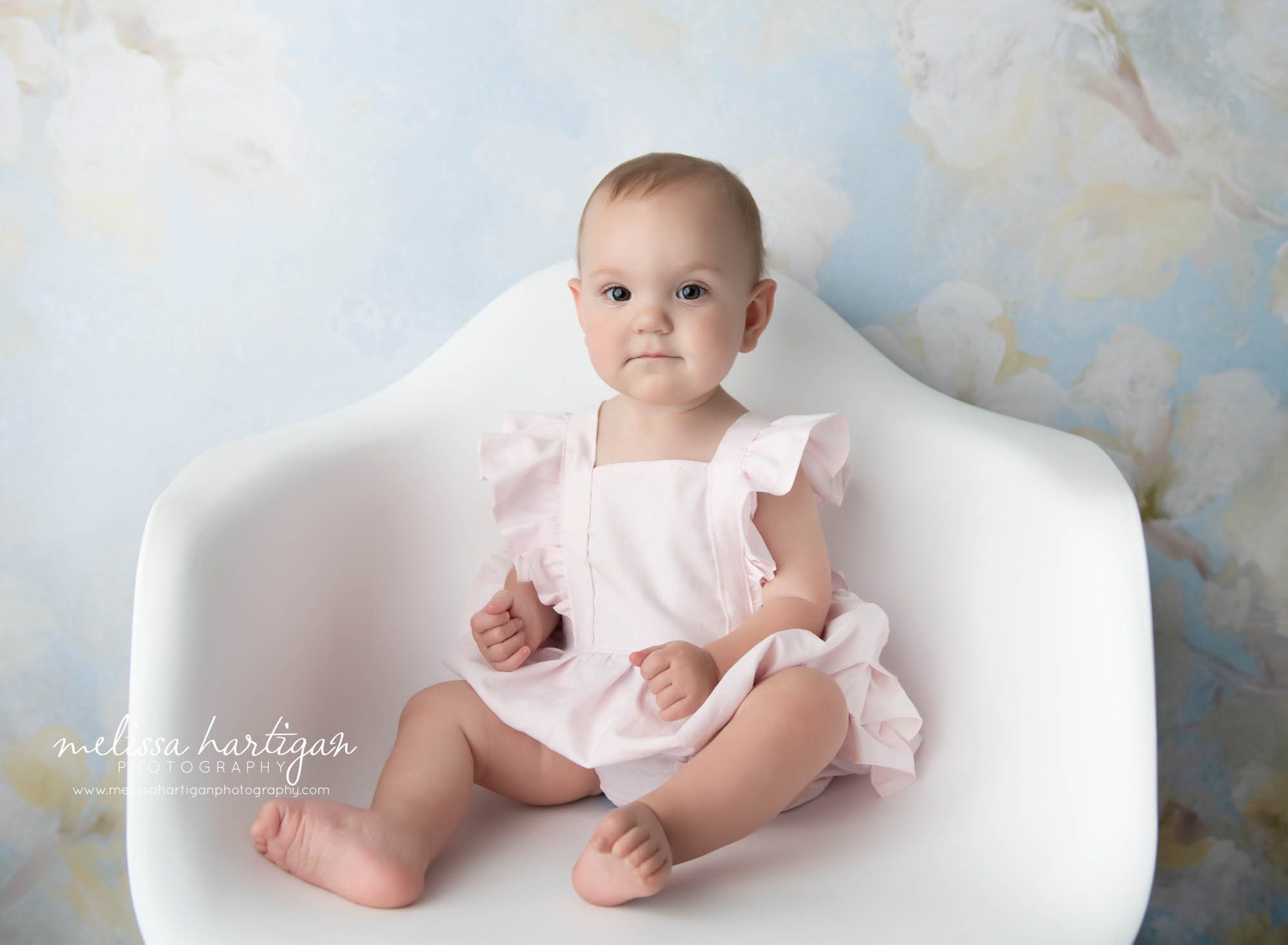 baby girl sitting in white chair photography studio CT