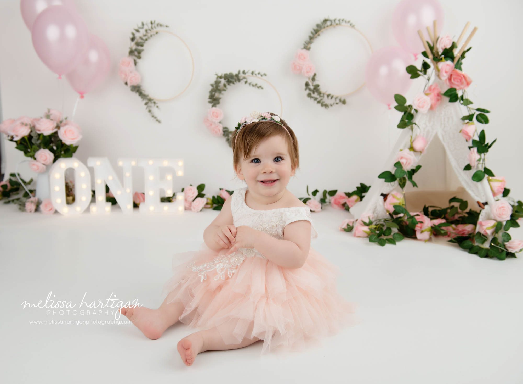 baby girl sitting on floor wearing cream and pink tulle dress and headband west baby photography west hartford